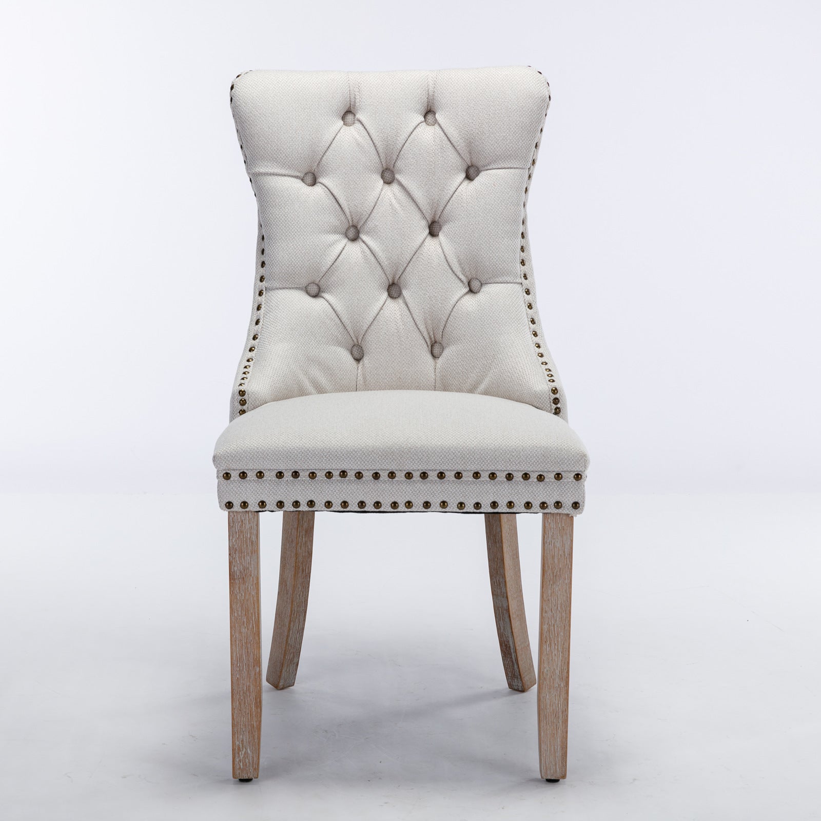 Tufted cream upholstered dining chair with nailhead trim and wooden legs