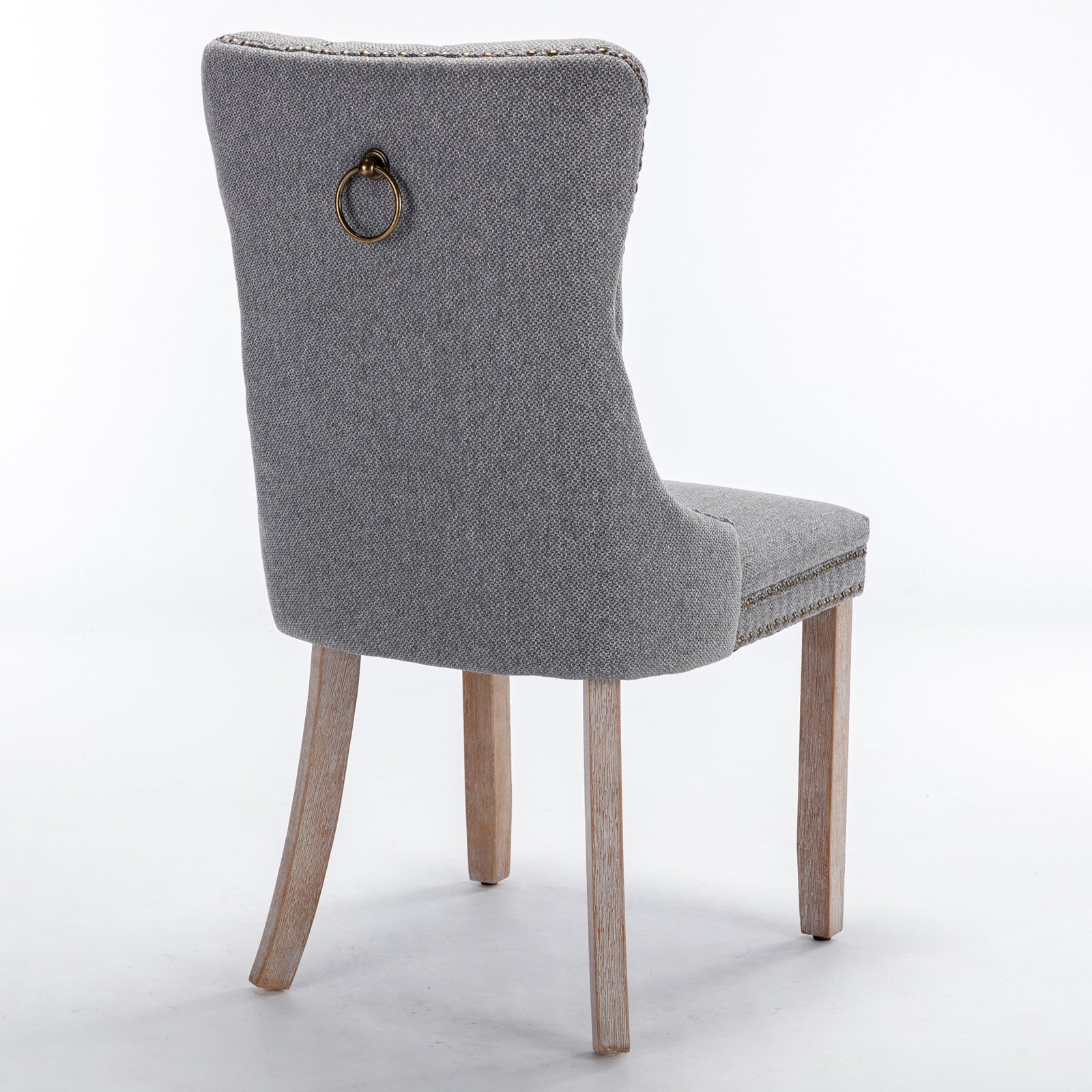Grey fabric dining chair with antique brass ring pull and nailhead trim