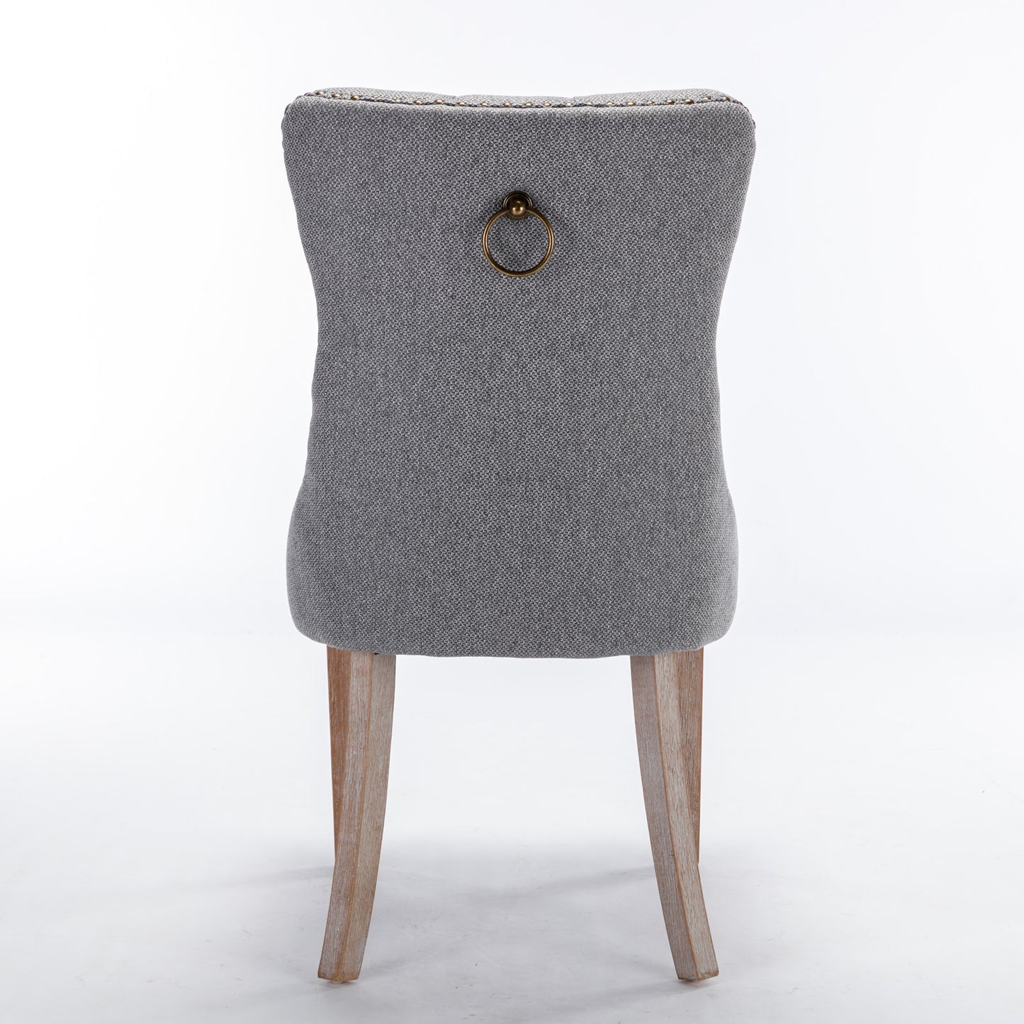 Gray upholstered dining chair with antique brass ring pull