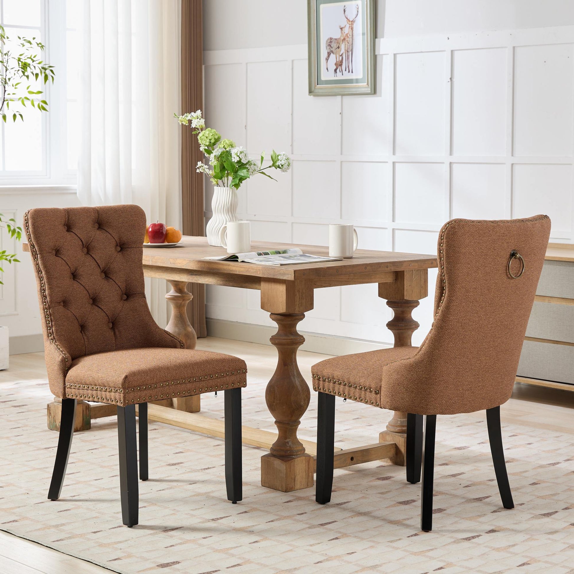 Tufted brown upholstered dining chair with nailhead trim and ring pull handle