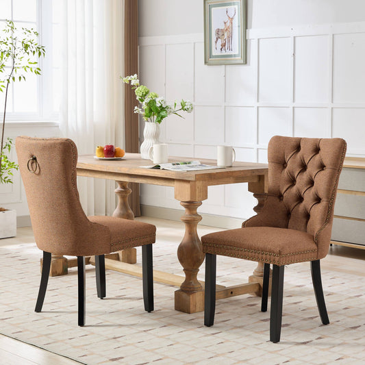 Brown tufted dining chair with gold nailhead trim and ring pull