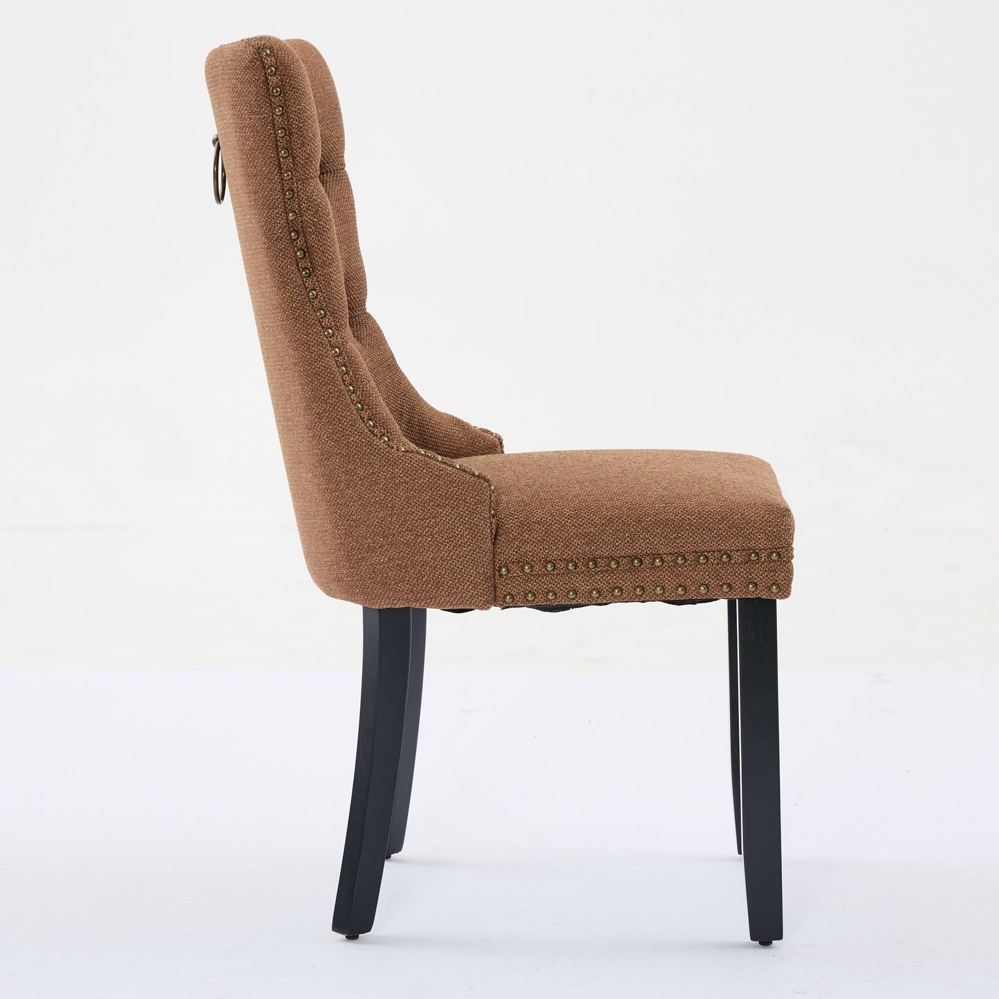 Brown tufted upholstered dining chair with bronze nailhead trim and ring pull handle