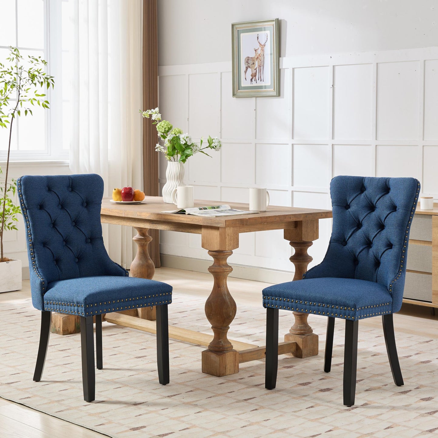 Blue upholstered dining chair with tufted back and nailhead trim