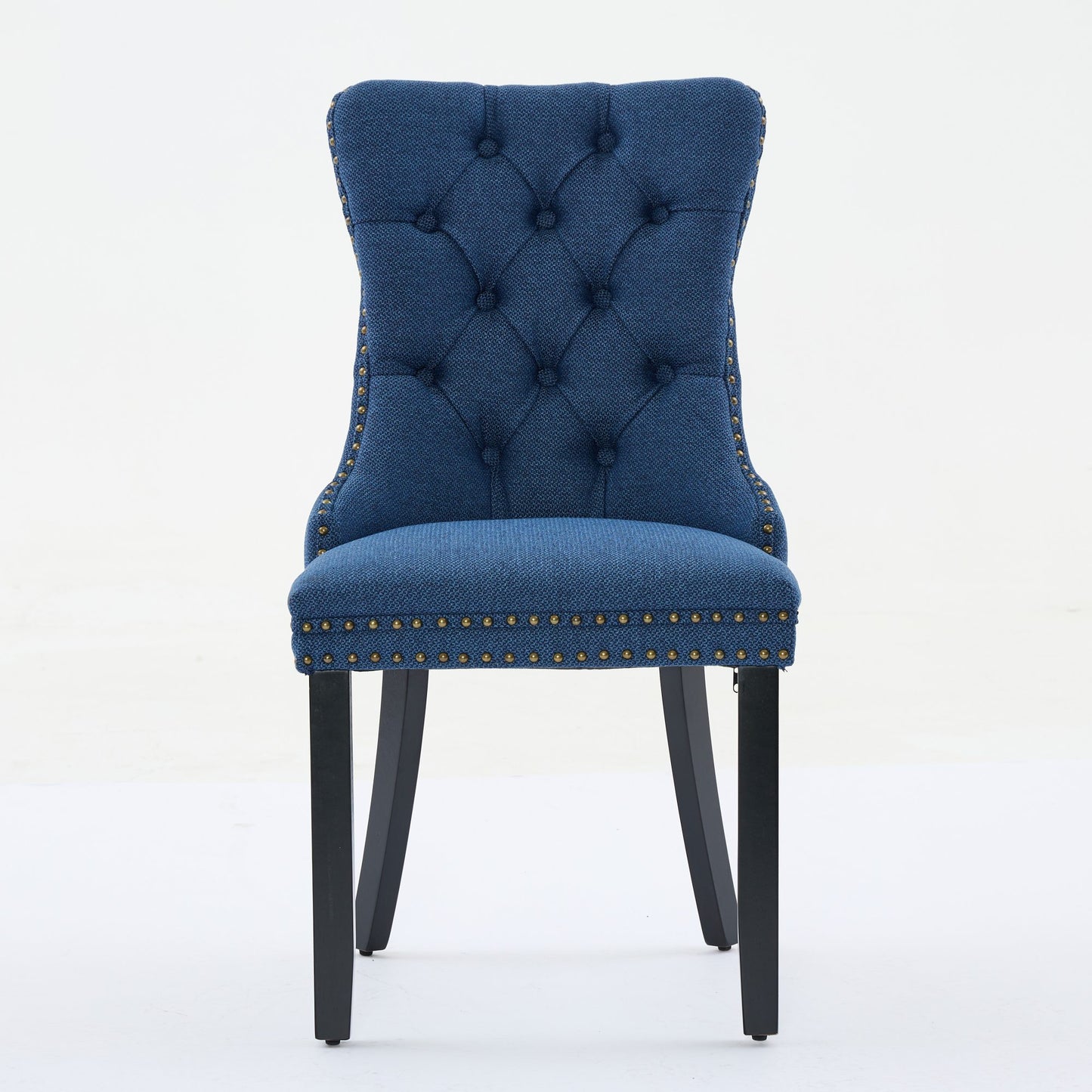 Tufted navy blue fabric dining chair with nailhead trim and dark wood legs