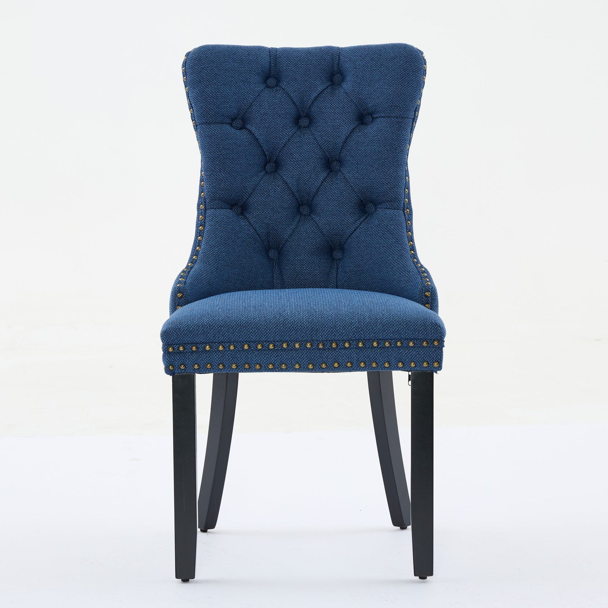 Tufted navy blue fabric dining chair with nailhead trim and dark wood legs