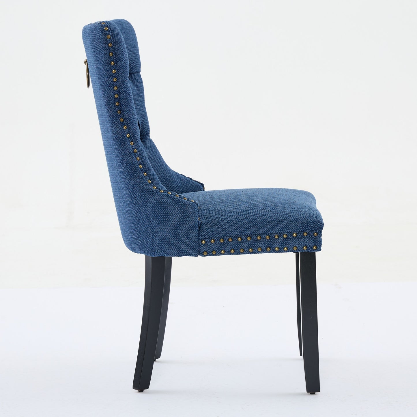 Blue upholstered dining chair with brass nailhead trim and ring pull