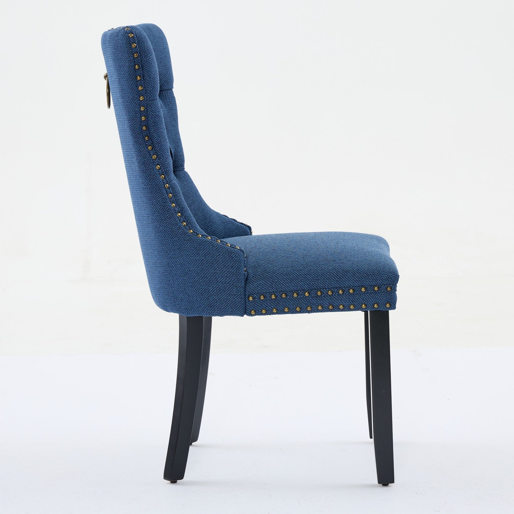 Blue upholstered dining chair with brass nailhead trim and ring pull