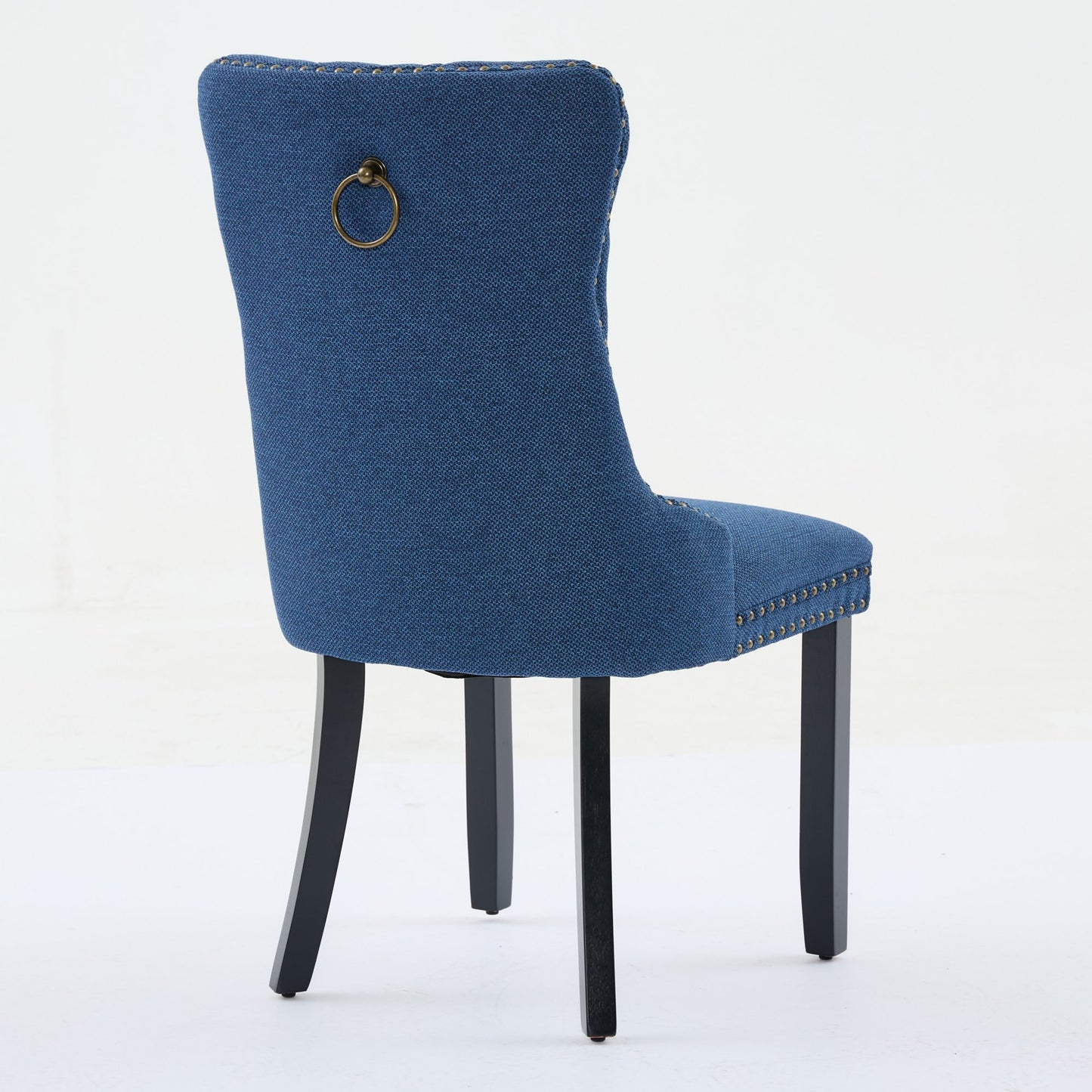 Blue upholstered dining chair with brass ring pull and nailhead trim