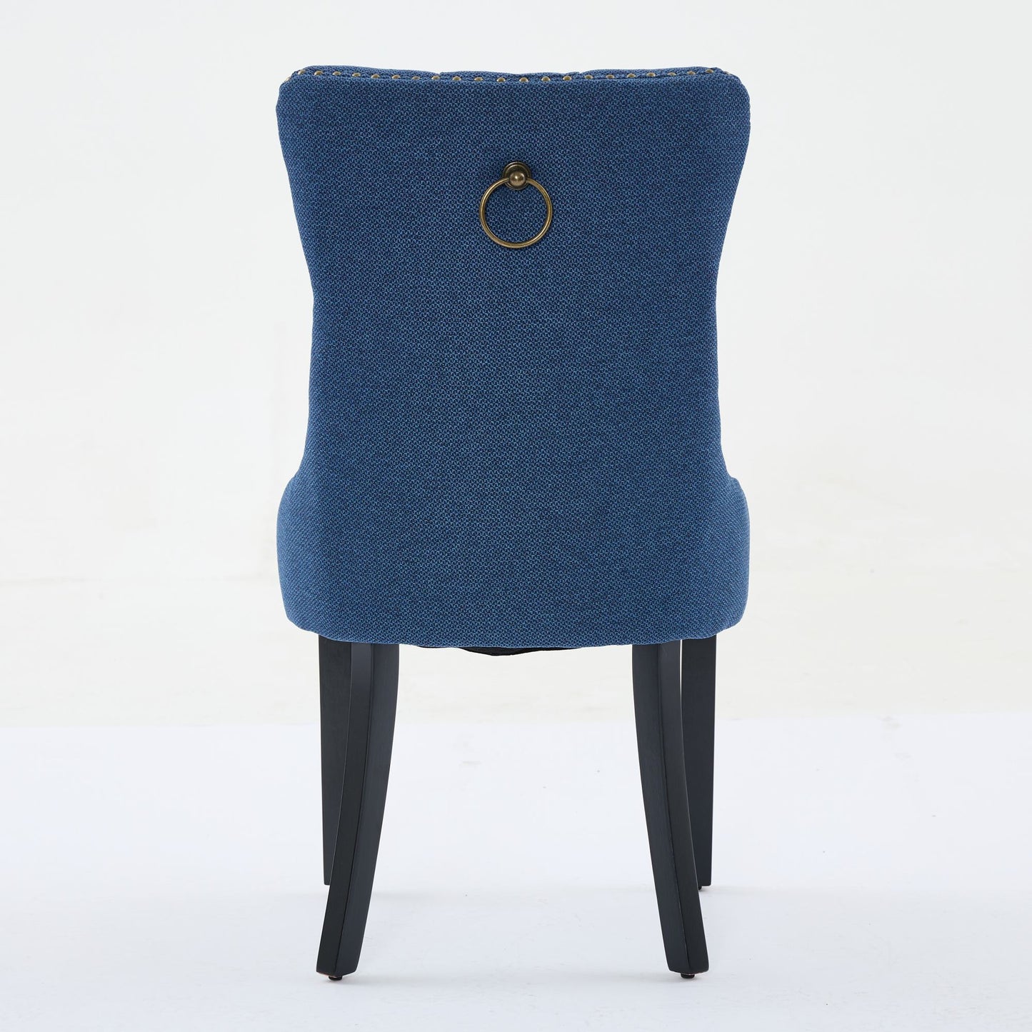 Blue upholstered dining chair with brass ring pull