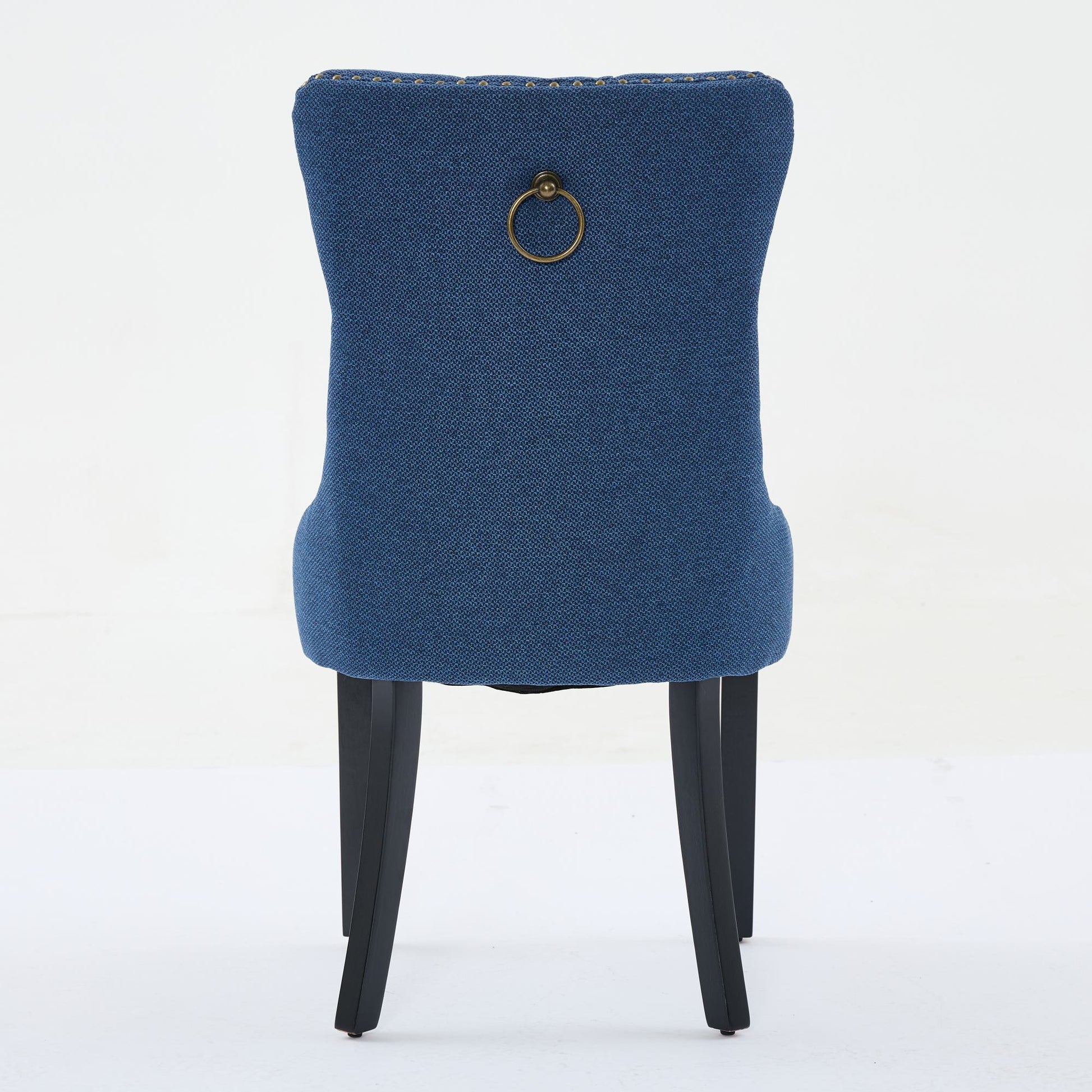 Blue upholstered dining chair with brass ring pull