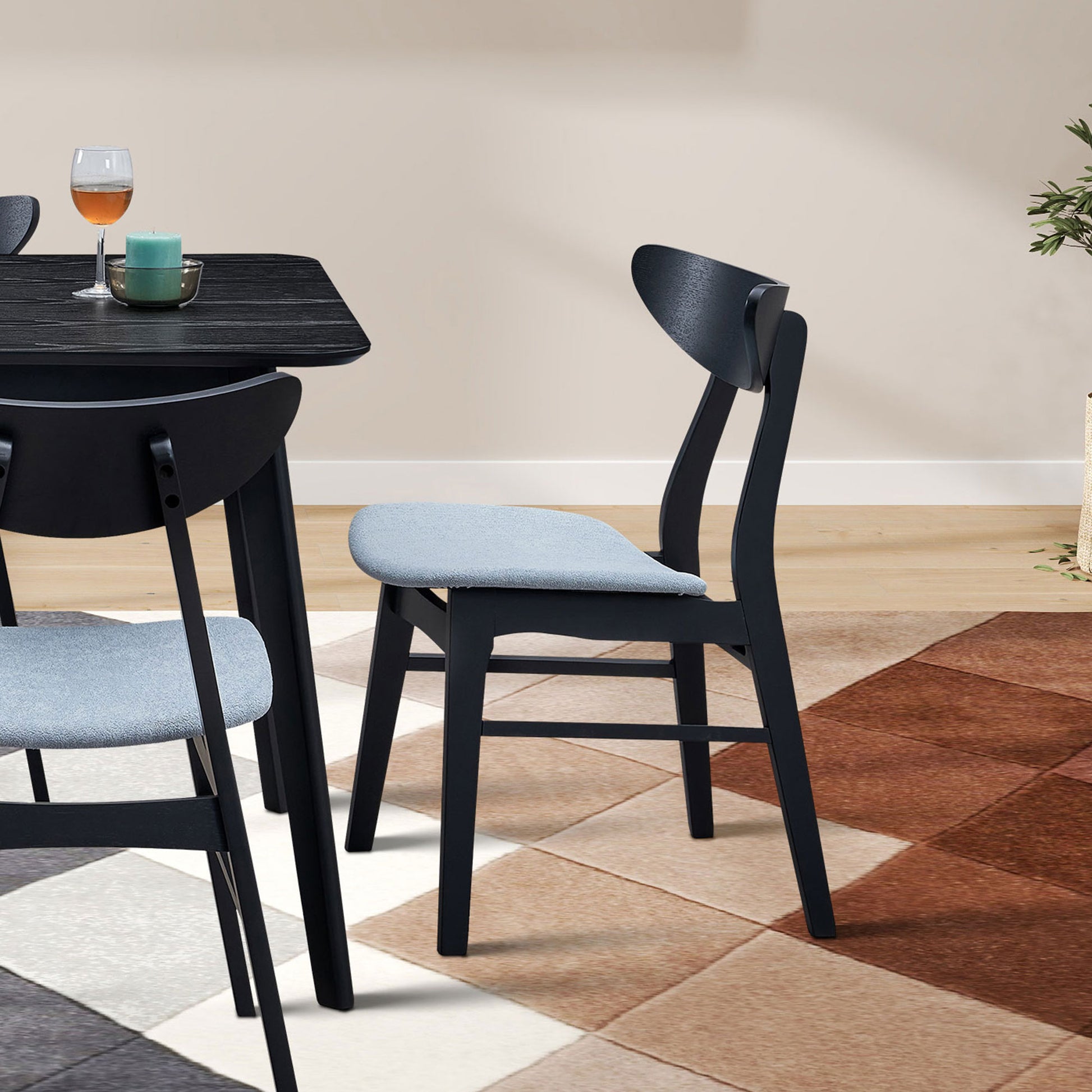 Modern black dining chair with light grey upholstered seat