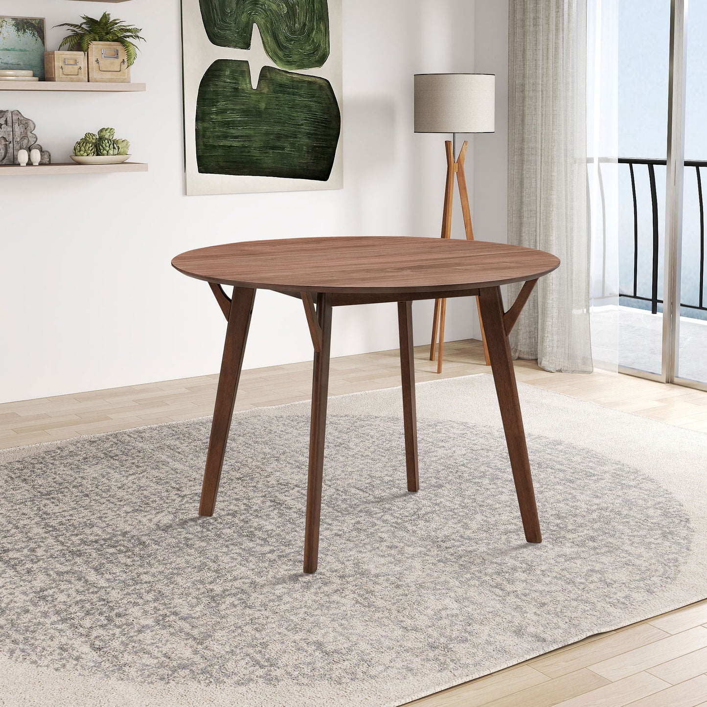 Round dark wood dining table with angled legs