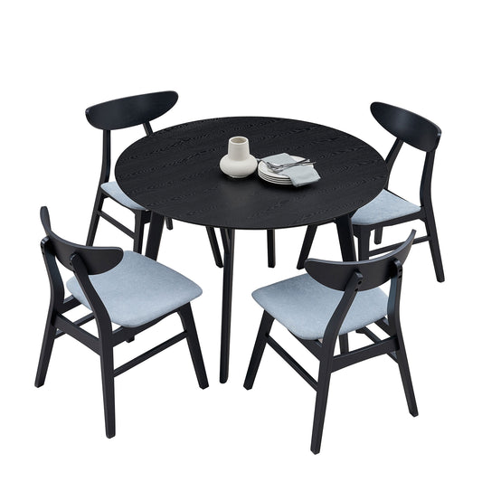 Black round dining table set with four grey upholstered chairs
