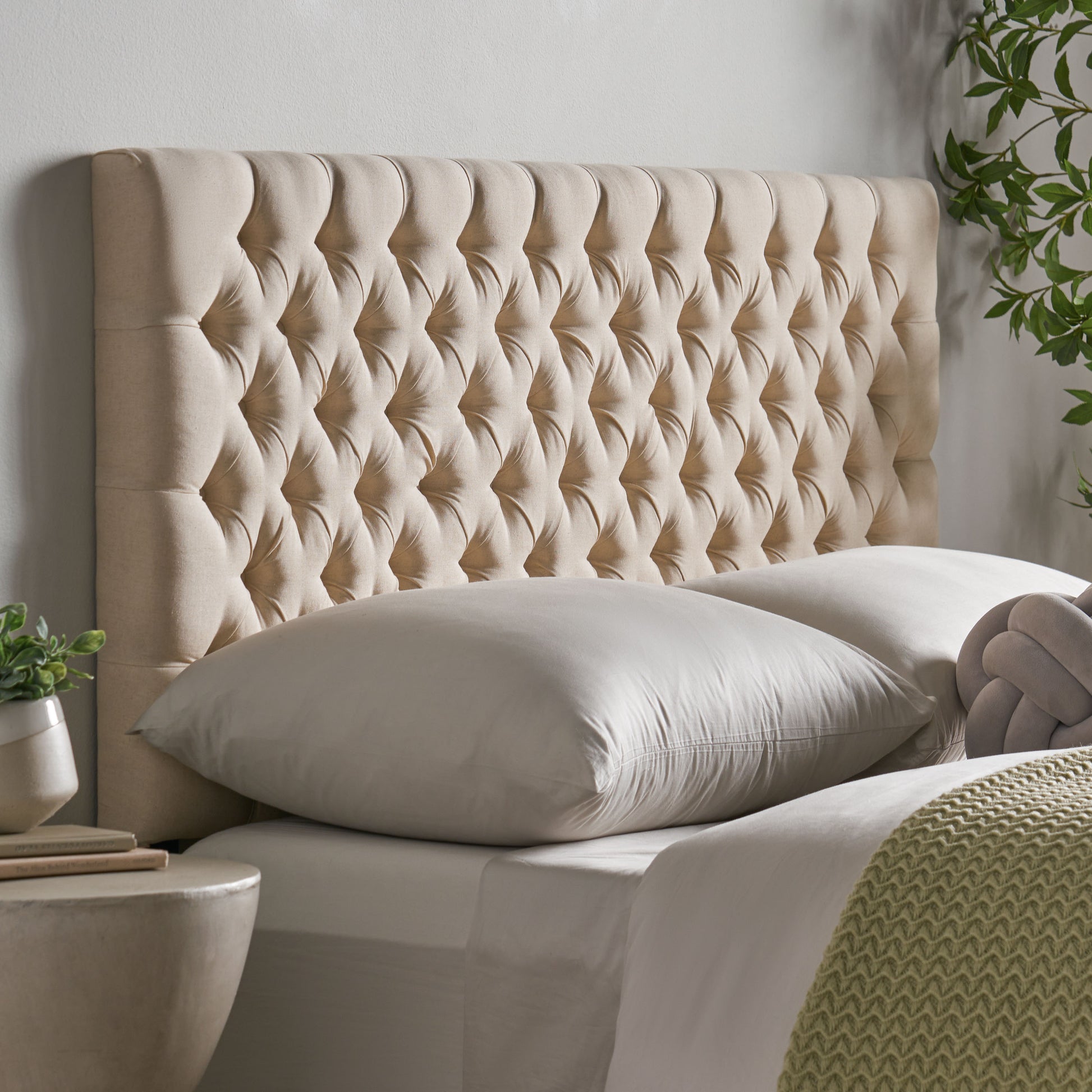 Tufted beige linen headboard with diamond button tufting