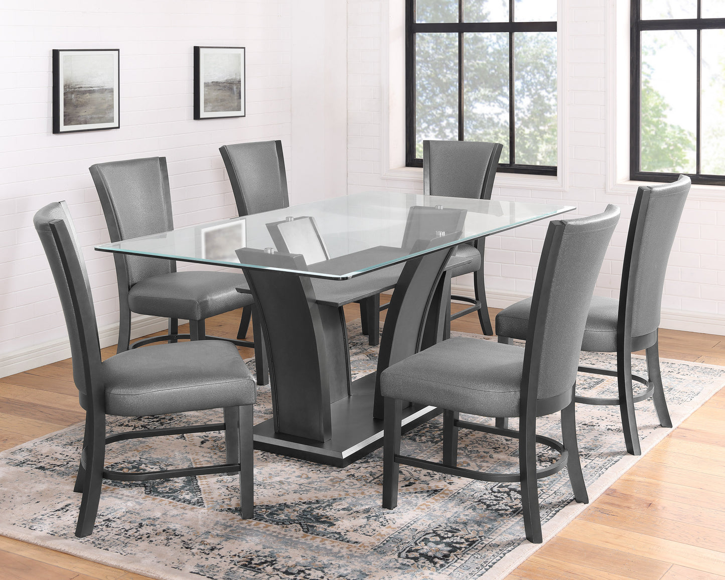 Glass top dining table with six grey upholstered chairs