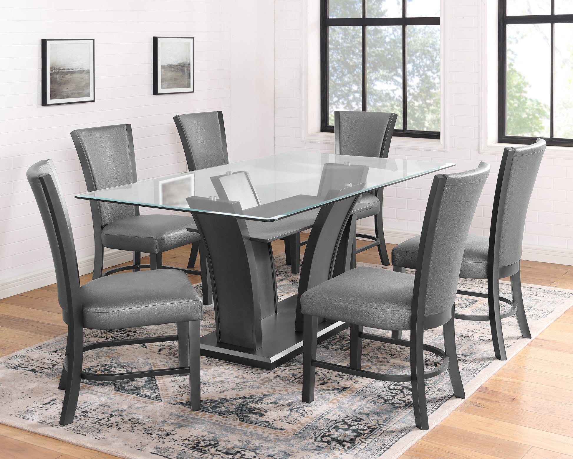 Glass top dining table with six grey upholstered chairs