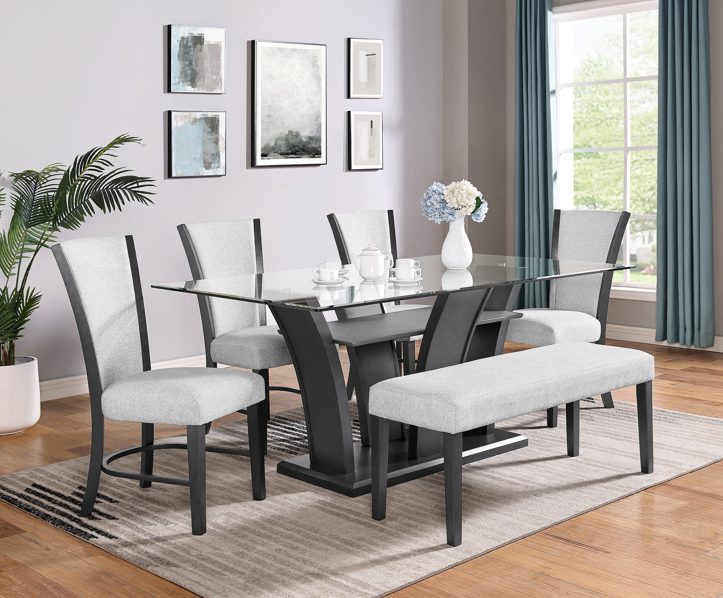 Glass top dining table with dark wood base and upholstered chairs