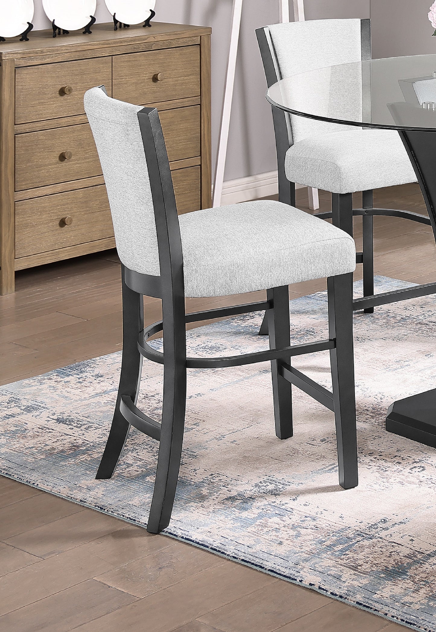Light gray upholstered counter stool with black wooden legs