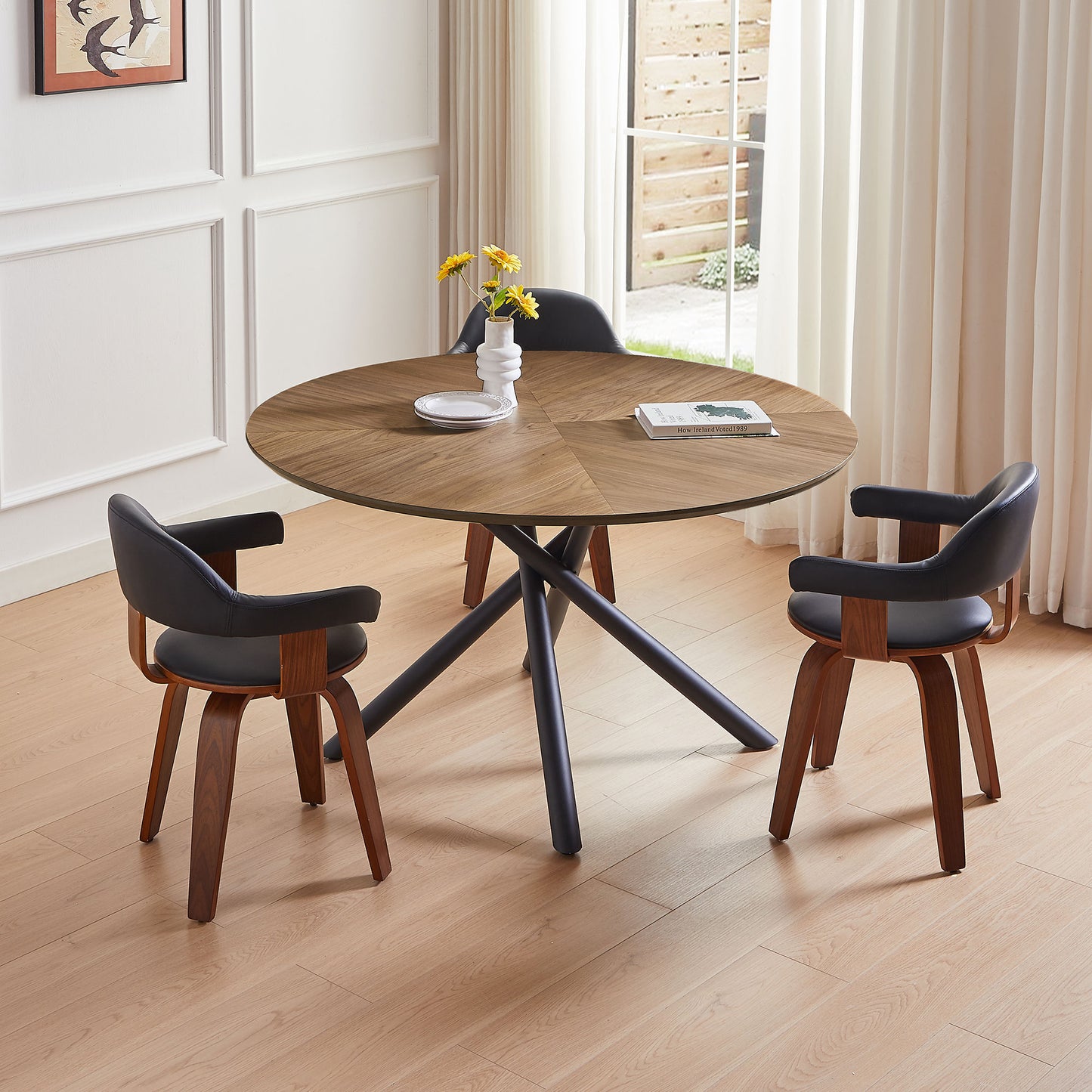 Round walnut veneer dining table with modern dark metal base