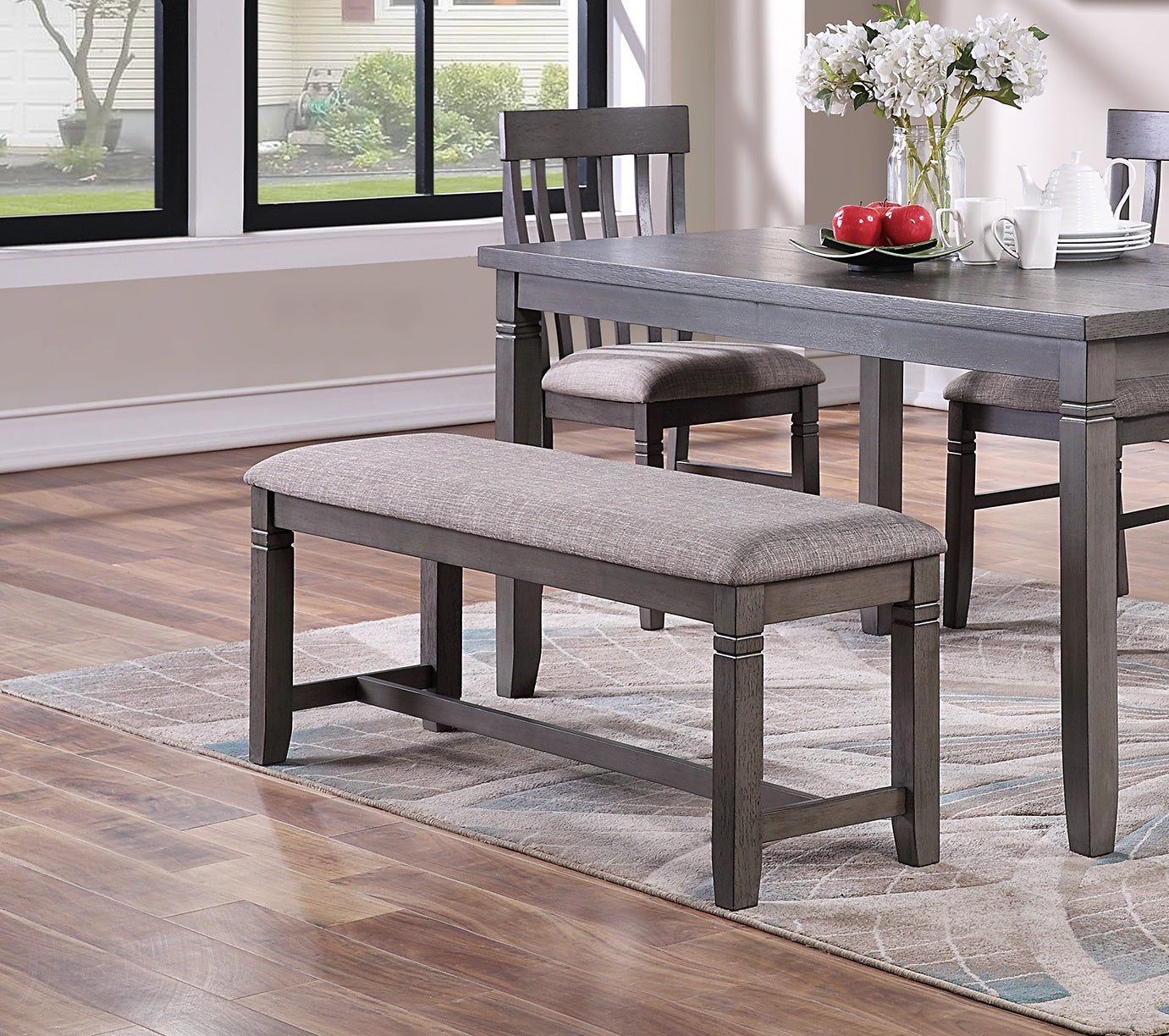Grey upholstered dining bench with wooden legs
