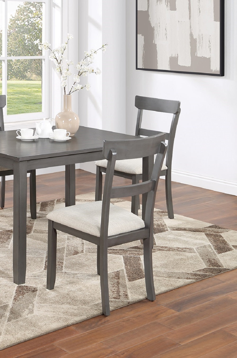 Gray dining chairs with upholstered seats around a gray table