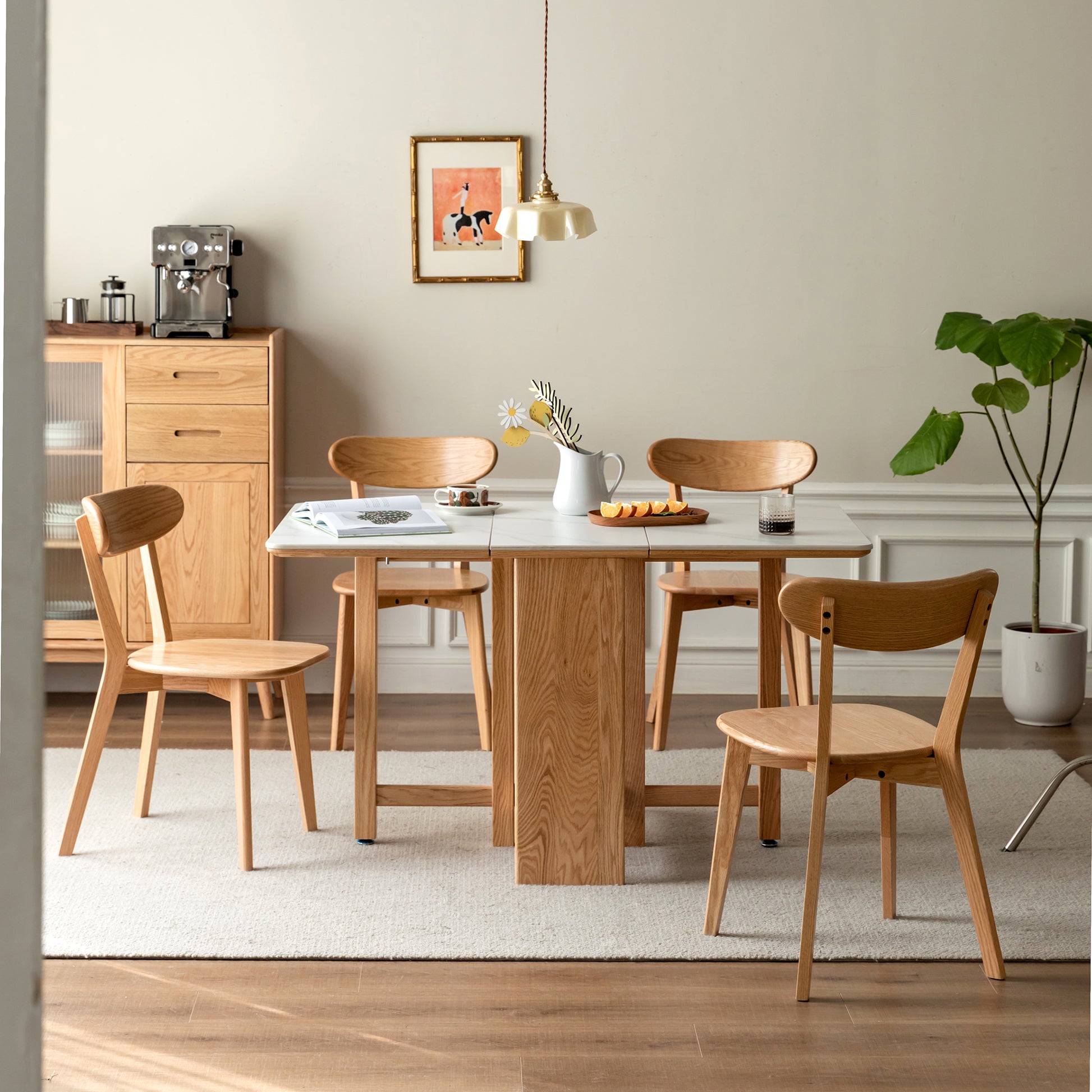 Modern light oak dining table with extending leaf and four matching chairs