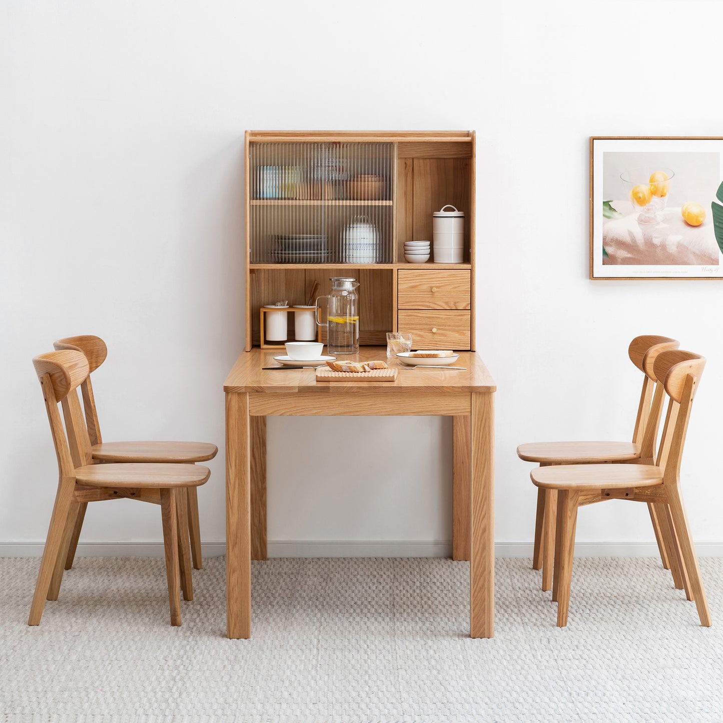 Natural oak dining table with fluted glass cabinet and minimalist chairs
