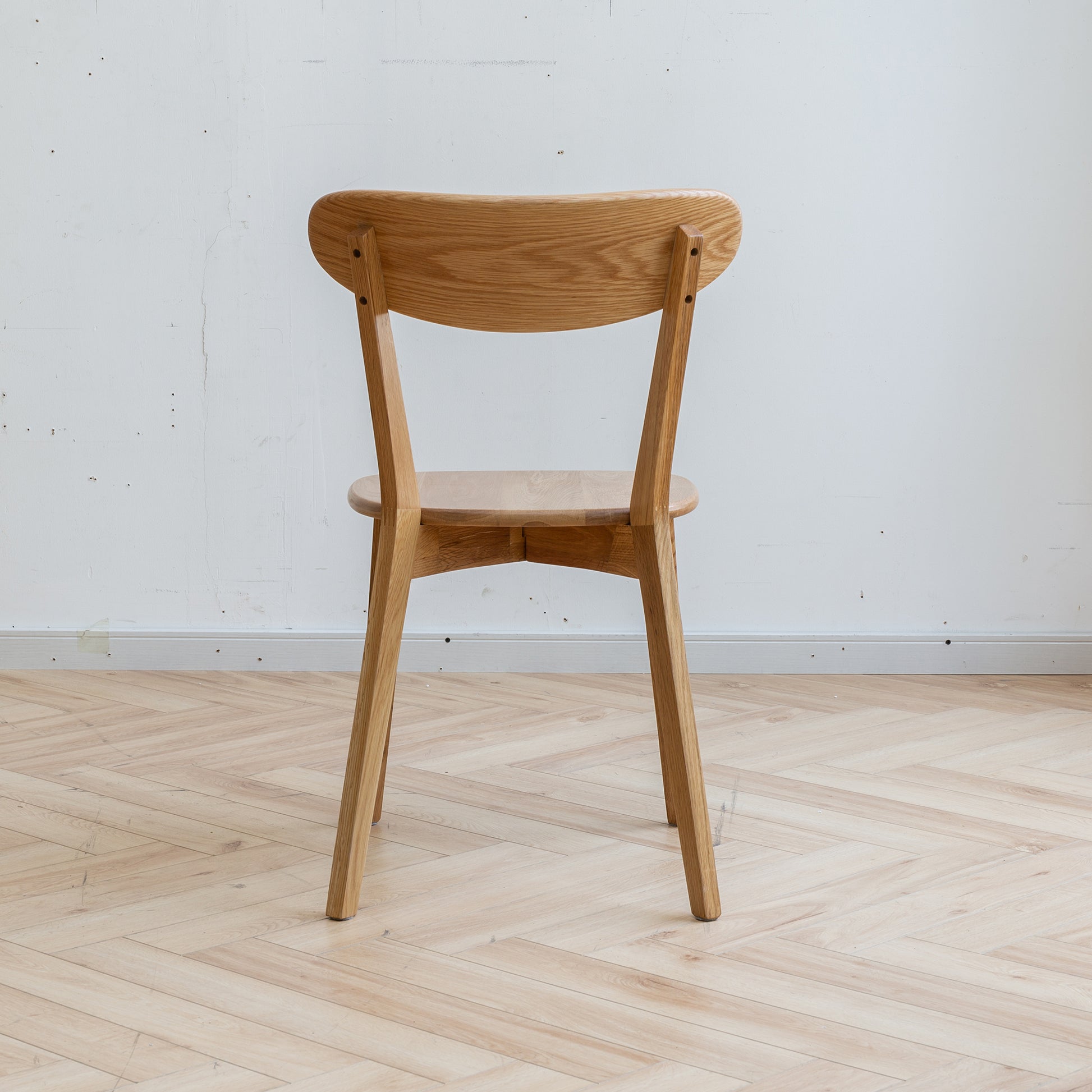 Light oak dining chair with curved back and wooden seat