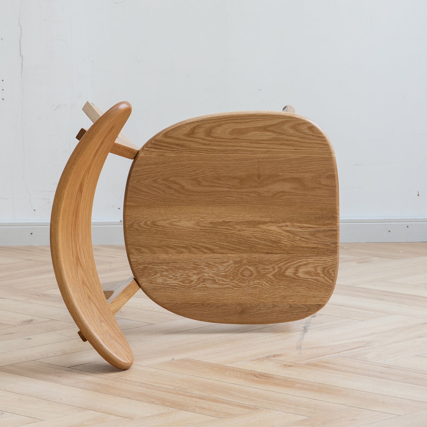 Curved solid oak wood chair with natural wood grain detail modern design