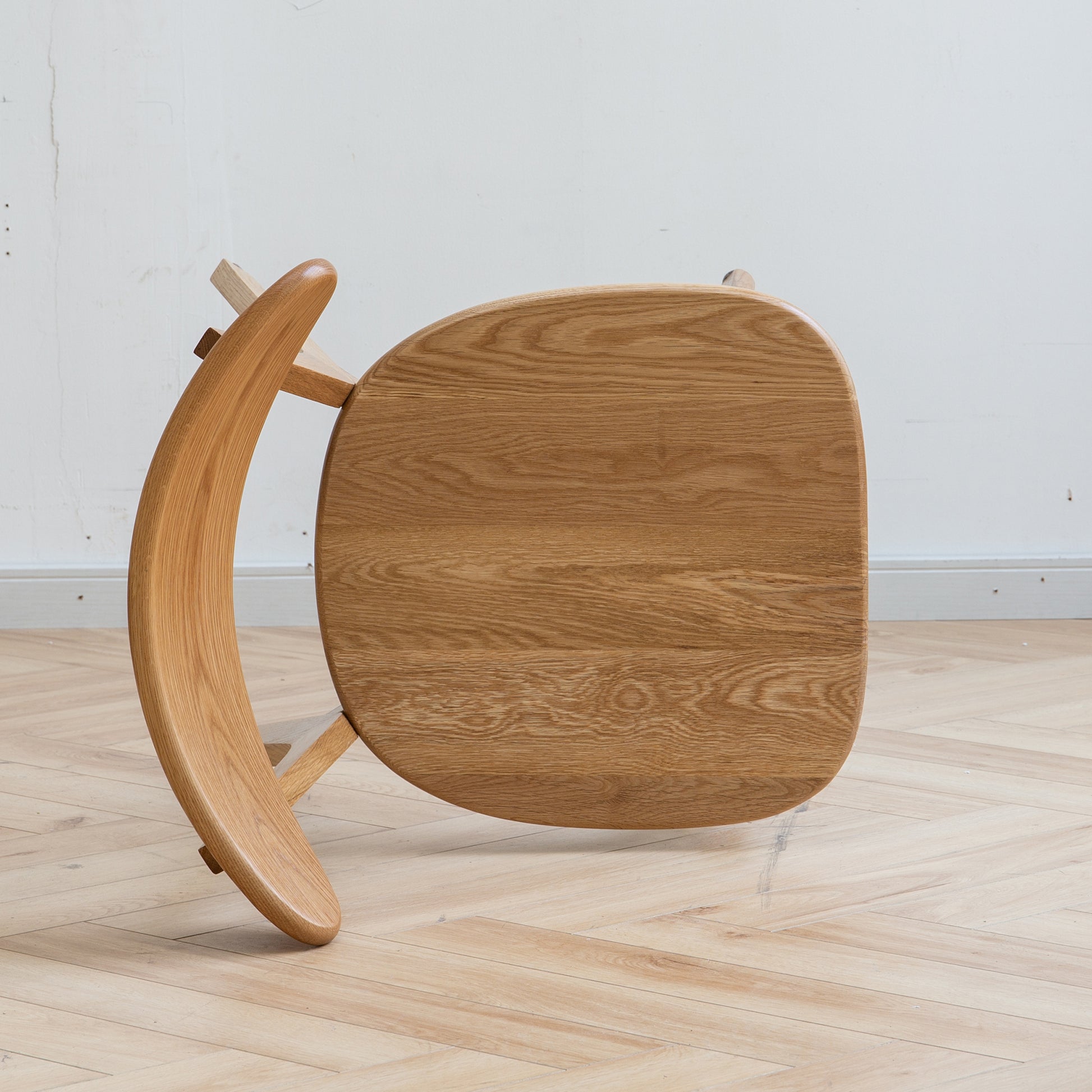 Curved solid oak wood chair with natural wood grain detail modern design