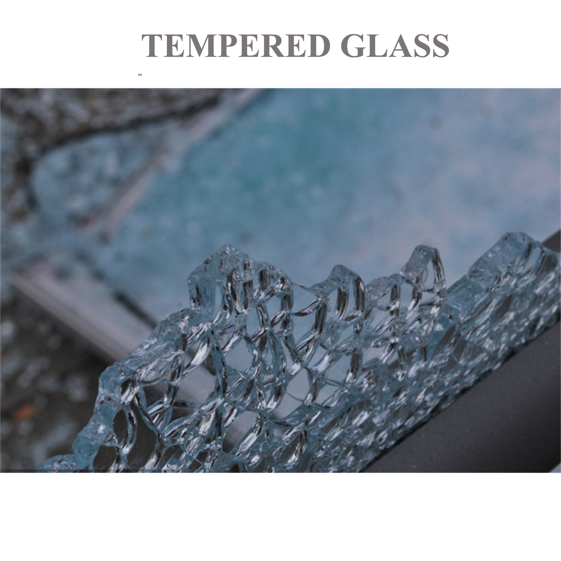 Closeup of a broken pane of clear tempered glass with a honeycomblike fracture pattern