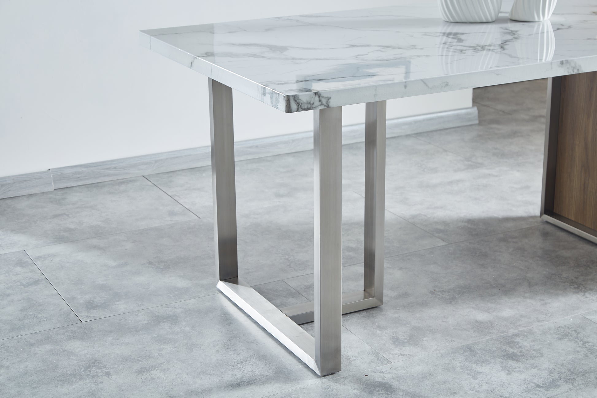 Modern marble top dining table with sleek brushed stainless steel legs