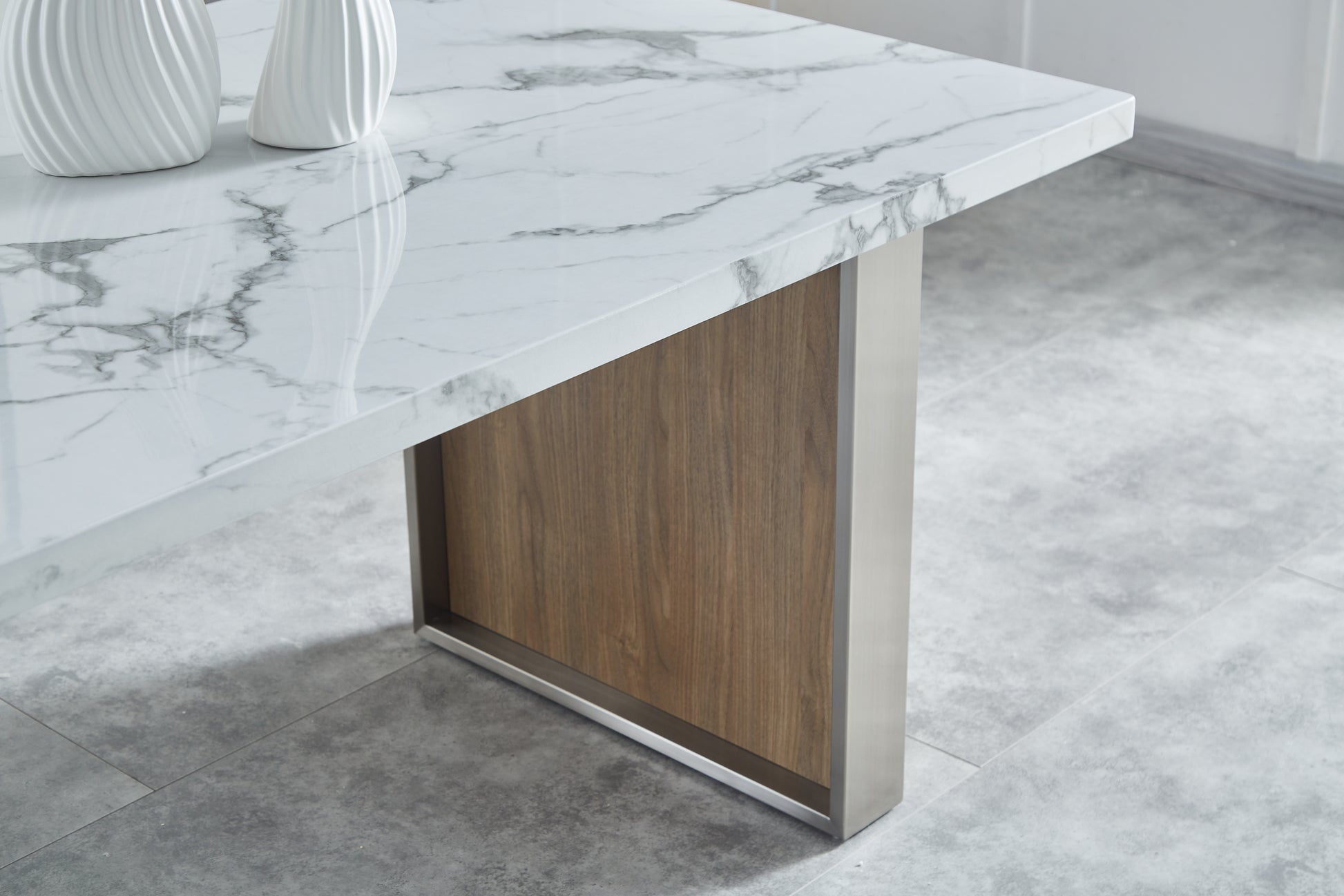 White marble dining table with brushed metal legs and wood panel accent