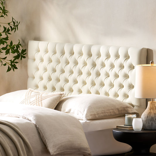 Cream upholstered diamond tufted headboard for a bedroom accent