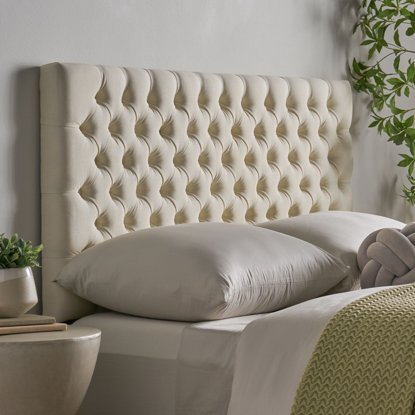 Cream tufted upholstered headboard with diamond button tufting