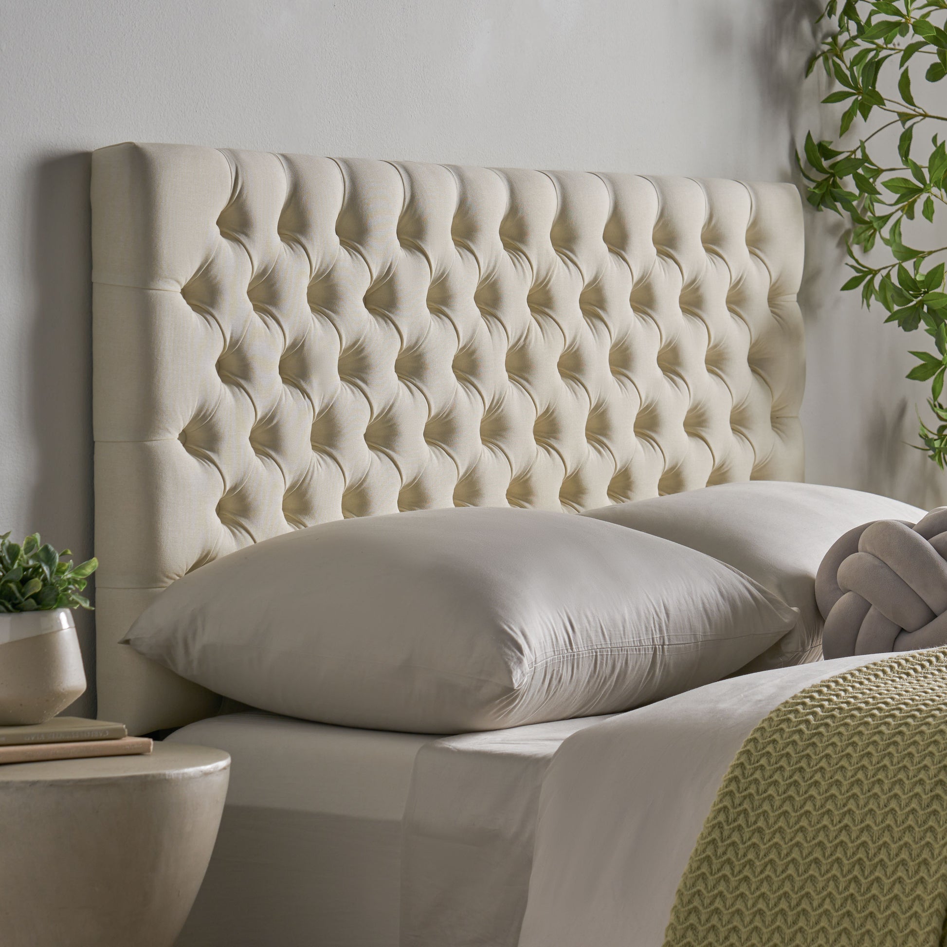 Cream tufted upholstered headboard with diamond button tufting