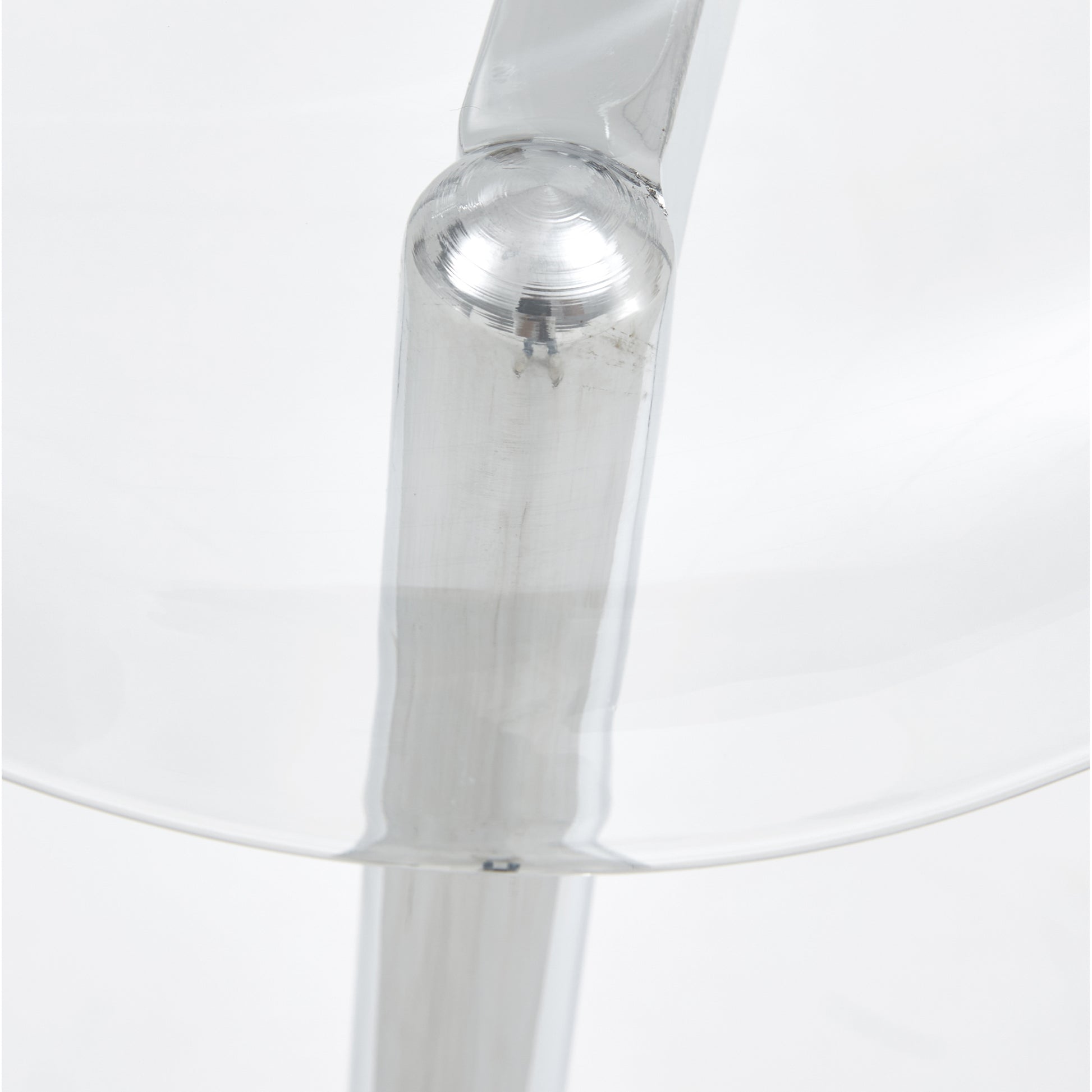 Closeup of polished chrome bar stool leg with circular texture