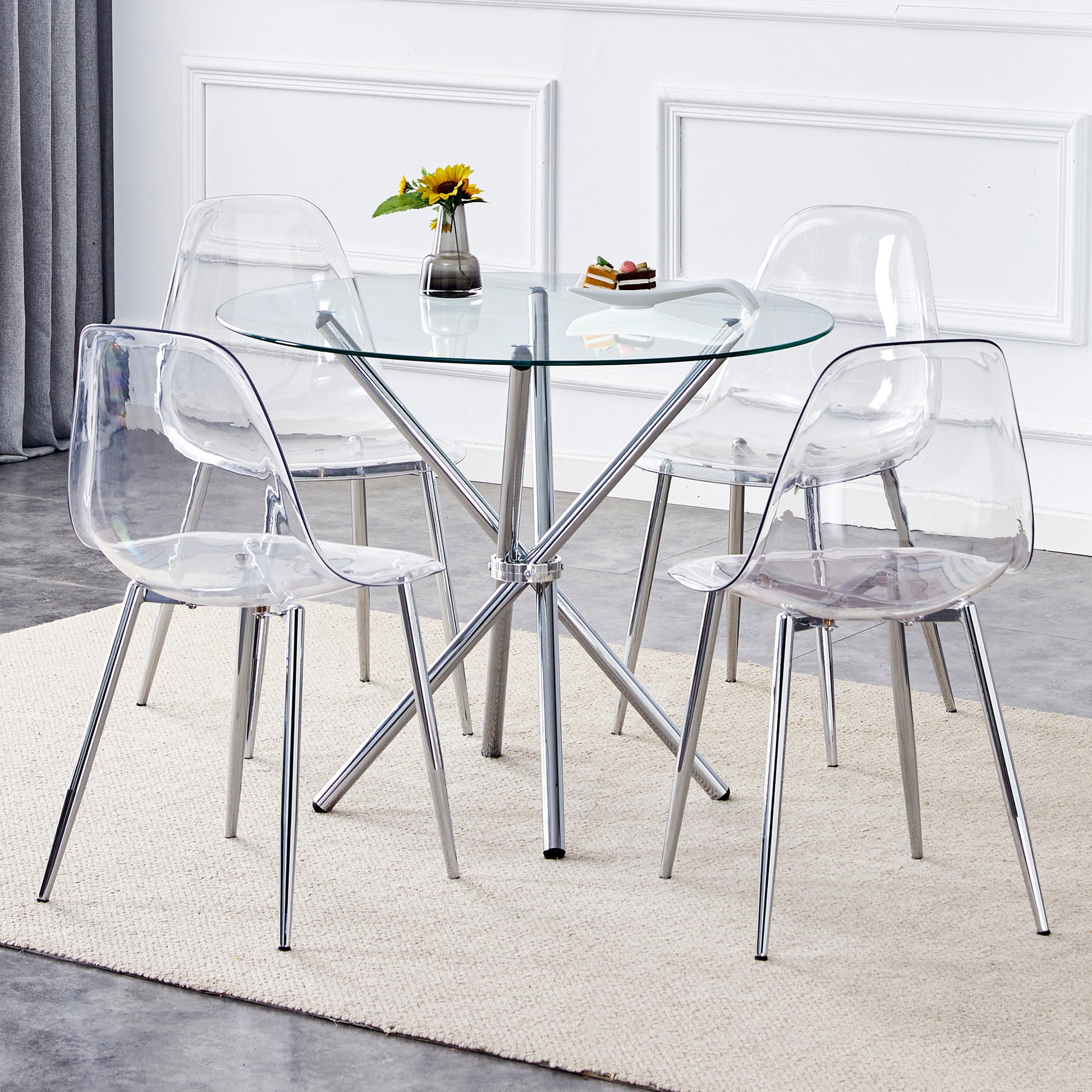 Clear acrylic dining chairs with chrome legs around a glasstop table
