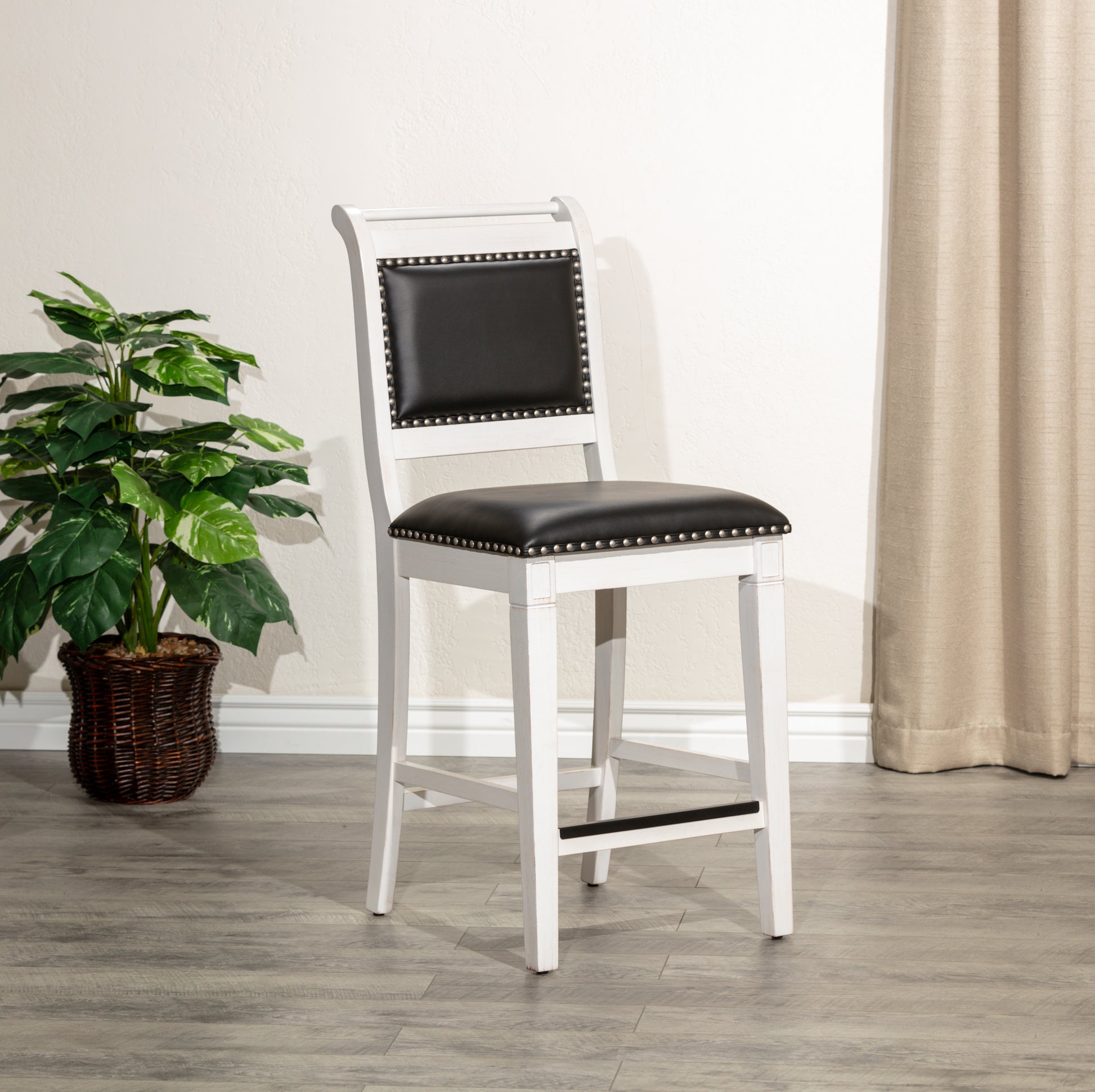 White wooden bar stool with black leather seat and silver nailhead trim
