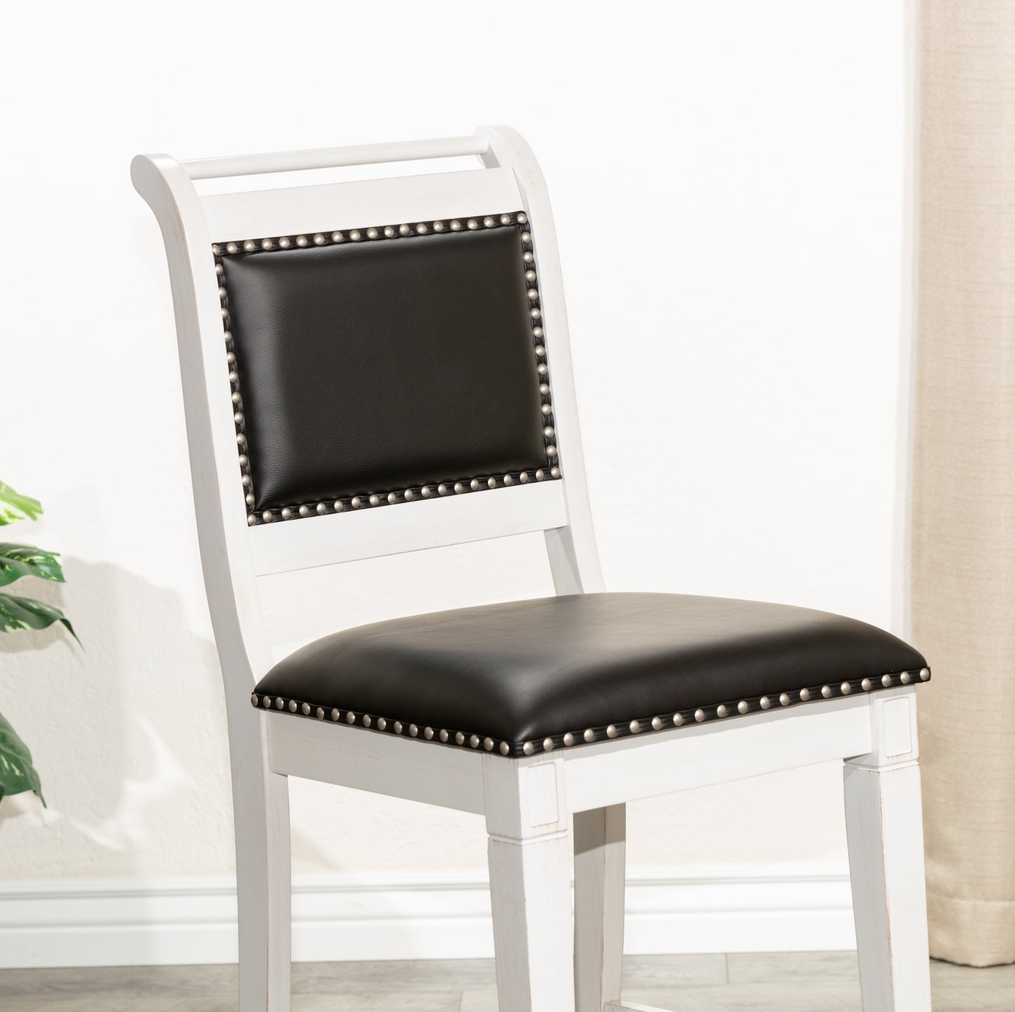 White distressed wood bar stool with black leather seat
