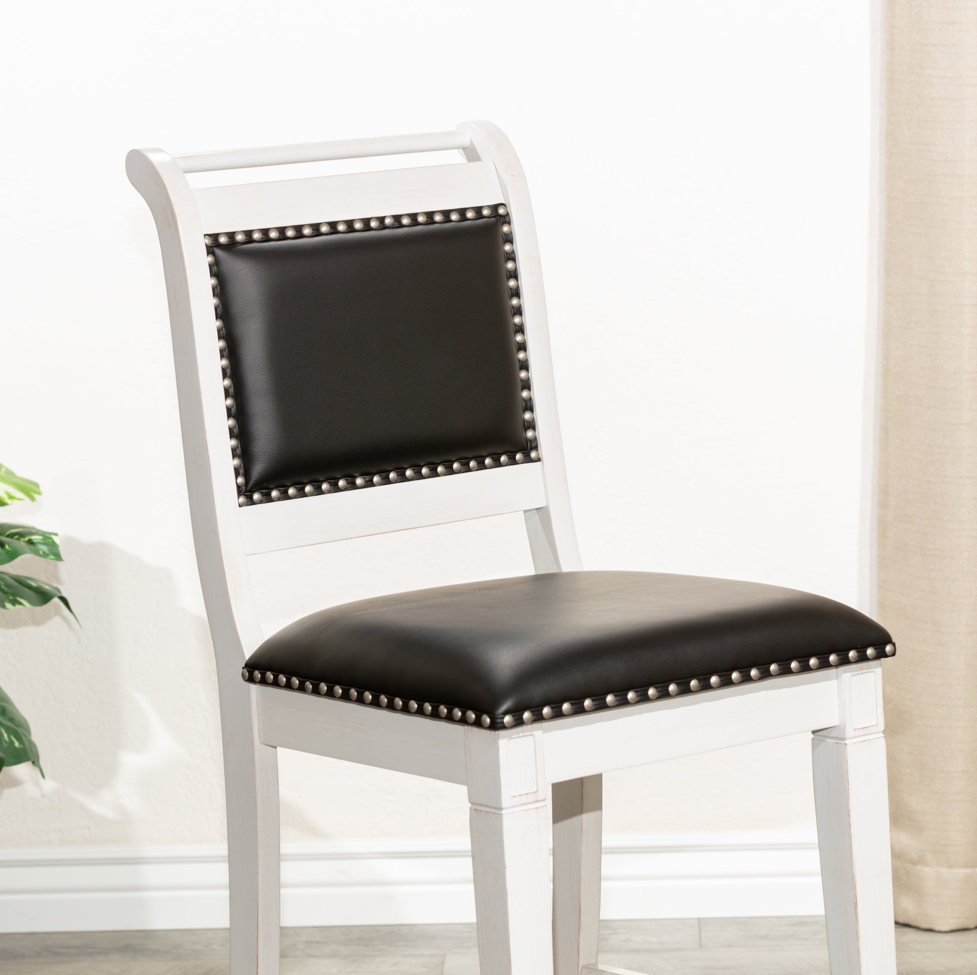 White distressed wood bar stool with black leather seat