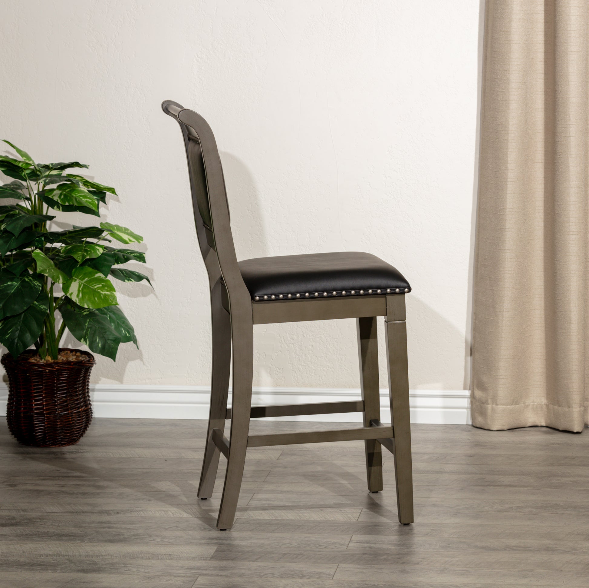 Gray wood bar stool with black leather seat and silver nailhead trim
