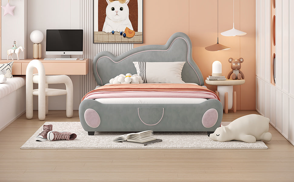 Grey upholstered twin bed with whimsical cloudlike headboard and pink accents