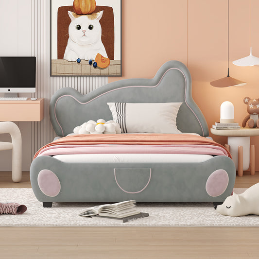 Grey upholstered twin bed with playful rounded edges and pink accents