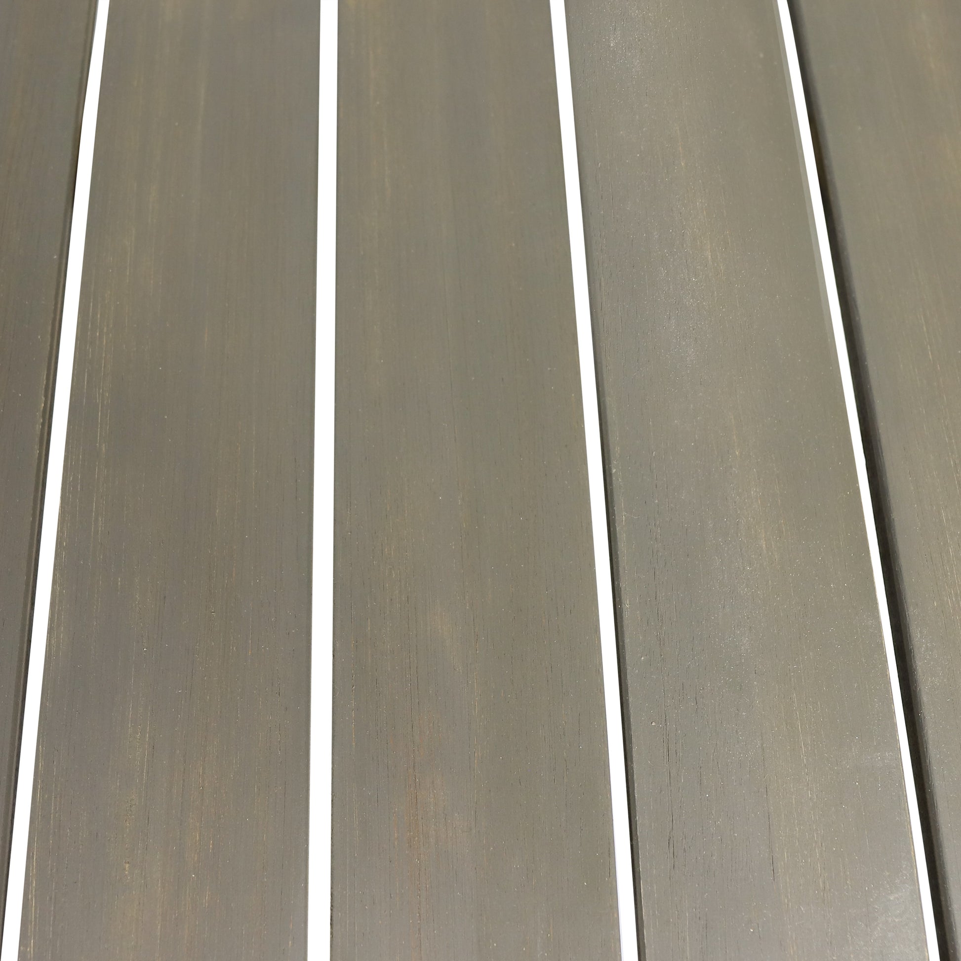 Closeup of dark grey wooden planks with white grout lines