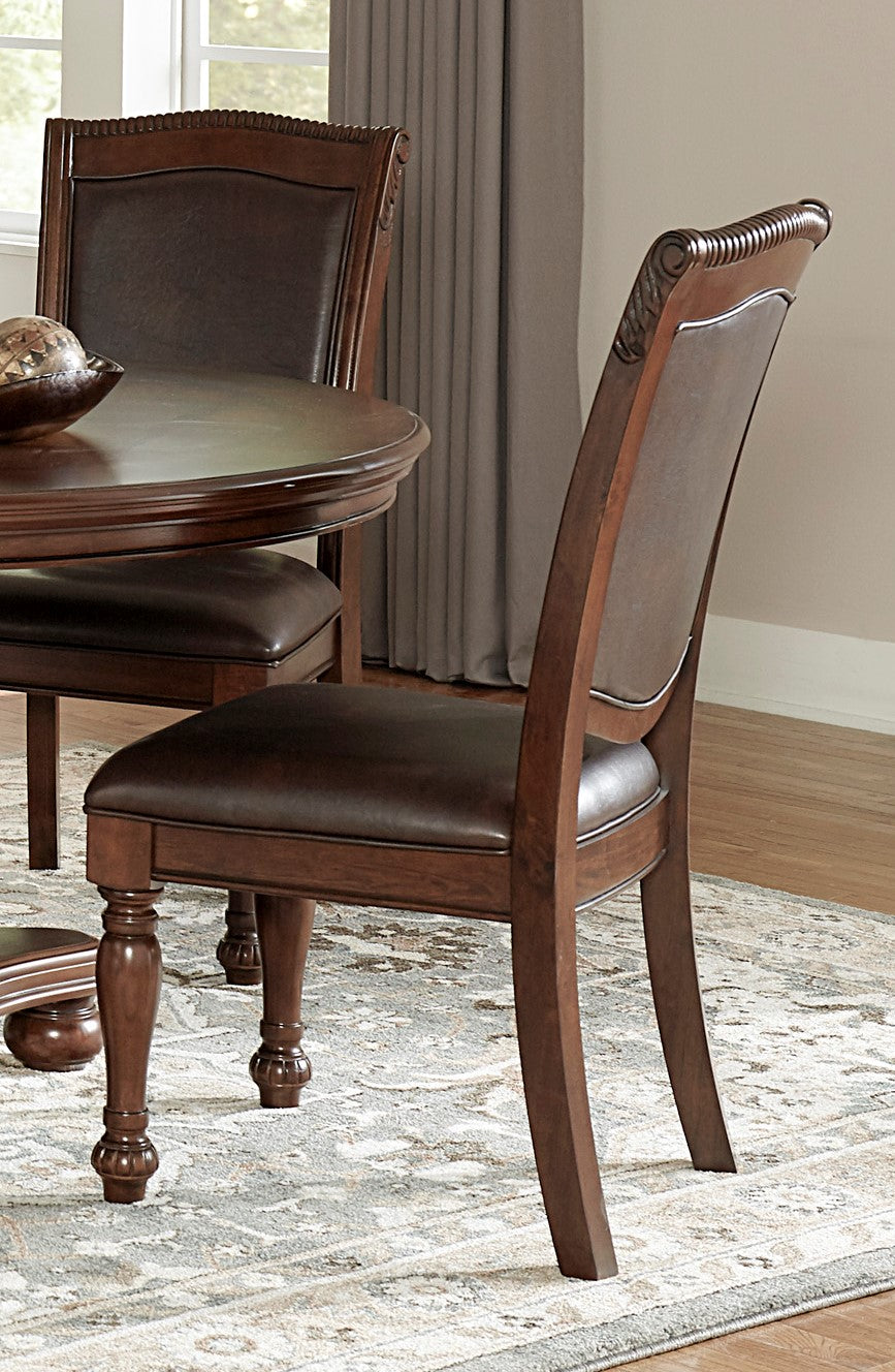 Dark brown leather upholstered dining chair with ornate wooden frame