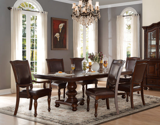 Ornate dark wood dining table with plush brown leather chairs