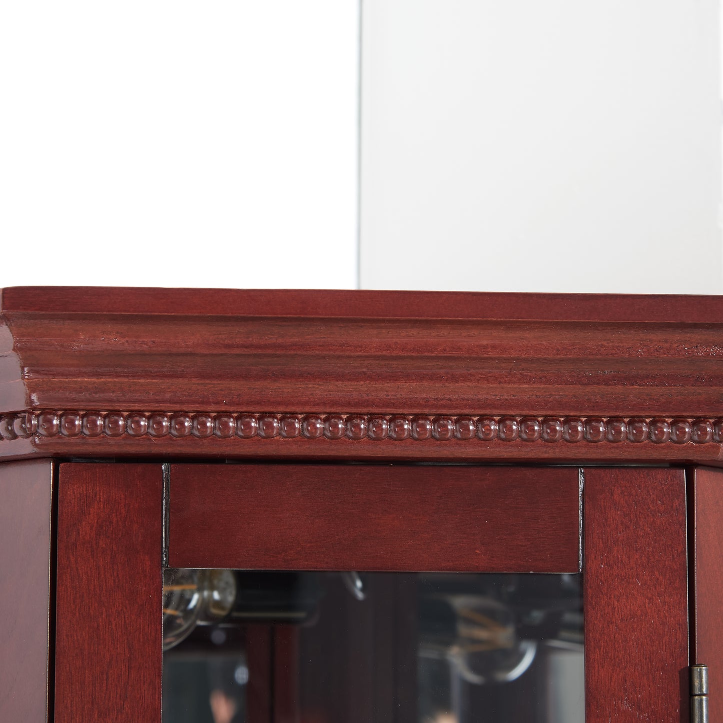 Mahogany corner cabinet top with beaded trim and glass door detail
