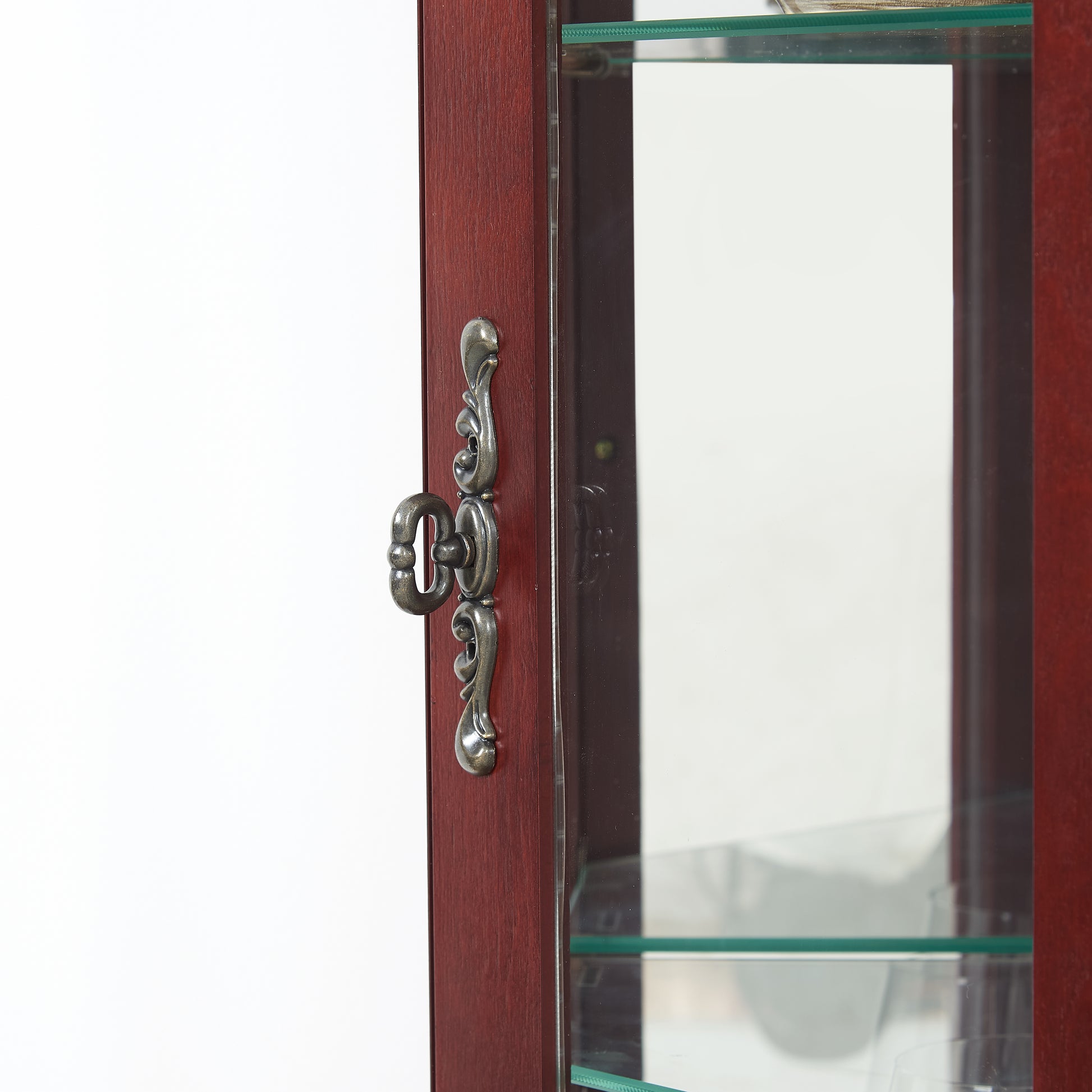 Mahogany curio cabinet with ornate silver handle