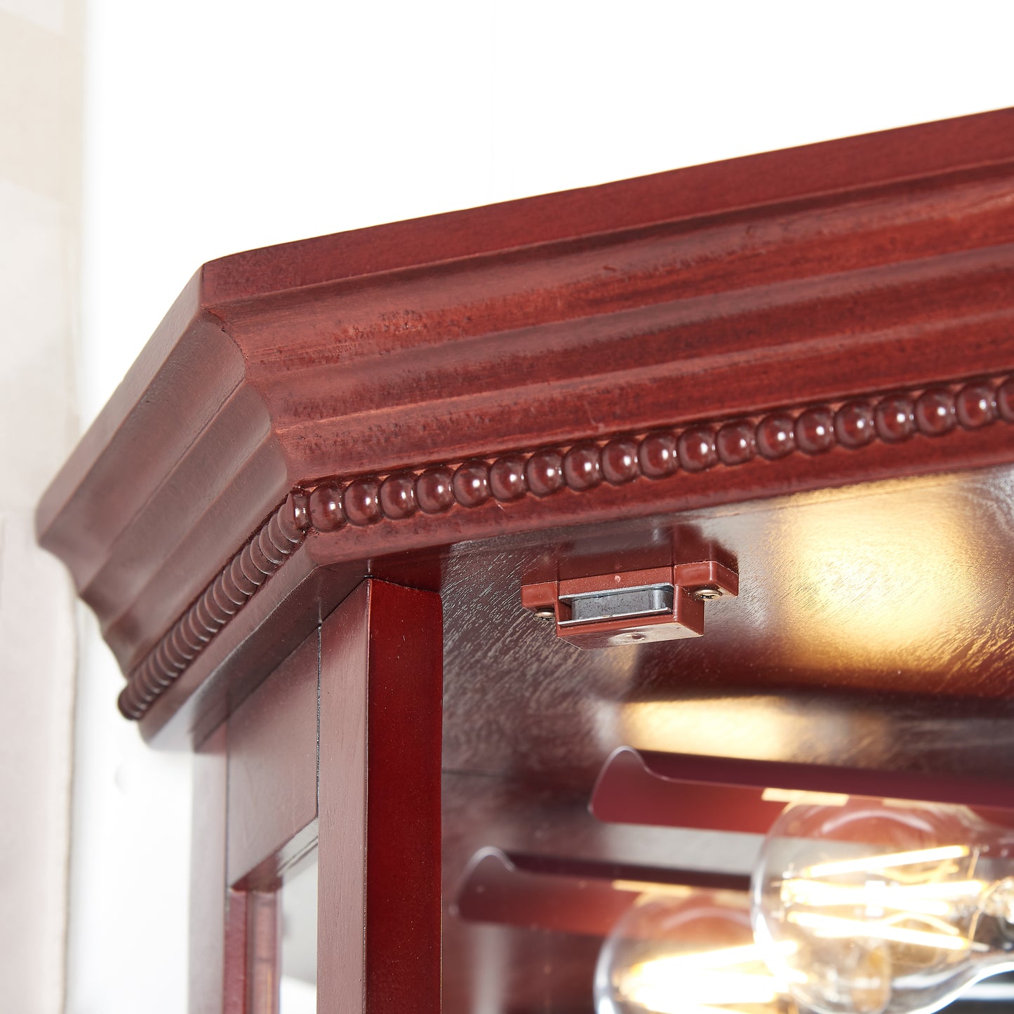 Rich mahogany wood cabinet top molding with beaded trim detail
